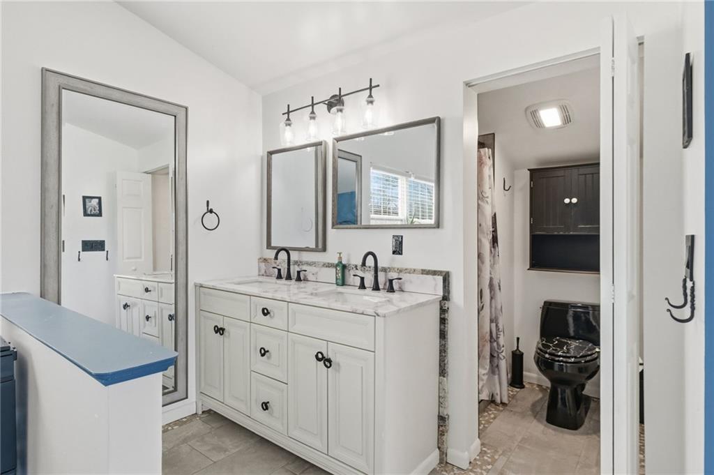 27 Bock Lane Baden, PA 15005 - Photo 33 of 50 a bathroom with a double vanity sink and mirror