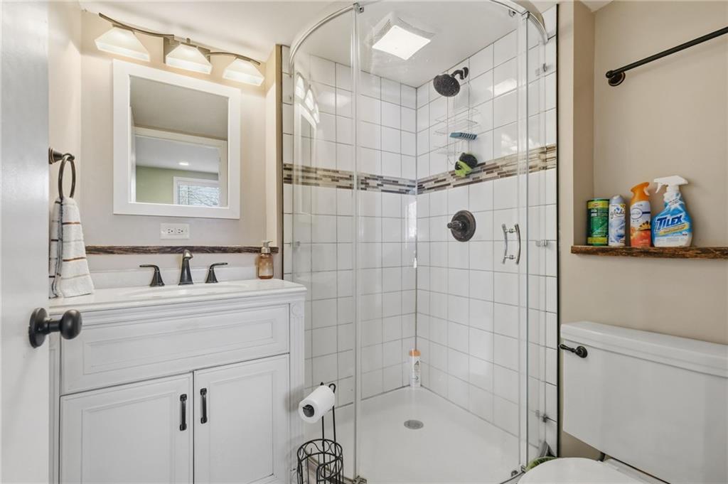 27 Bock Lane Baden, PA 15005 - Photo 44 of 50 a bathroom with a shower sink and mirror