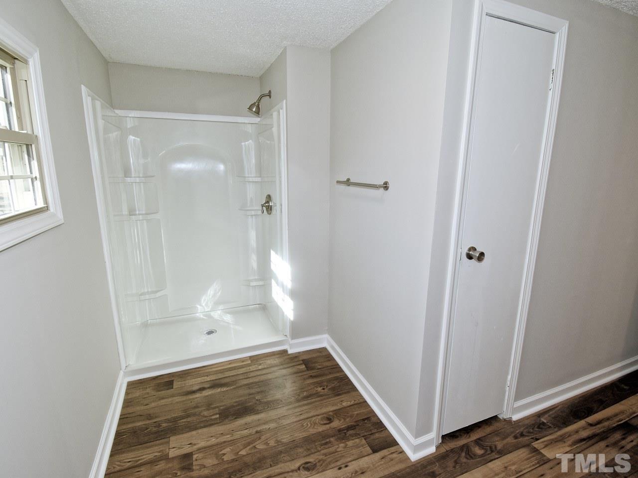 810 Dink Ashley Road Timberlake, NC 27583 - Photo 14 of 31 a bathroom with a glass door shower