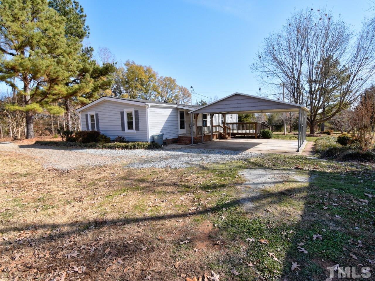 810 Dink Ashley Road Timberlake, NC 27583 - Photo 29 of 31 a view of a house with a yard covered in snow