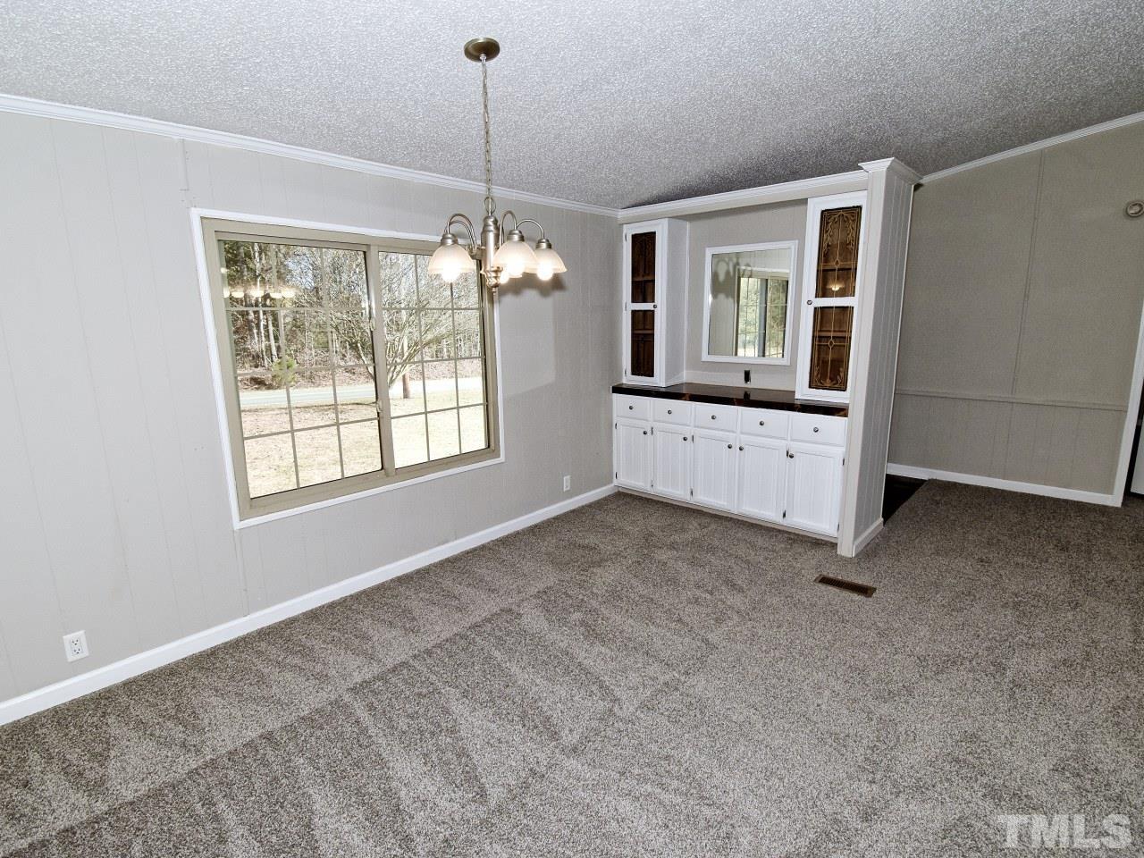 810 Dink Ashley Road Timberlake, NC 27583 - Photo 5 of 31 a view of livingroom with chandelier