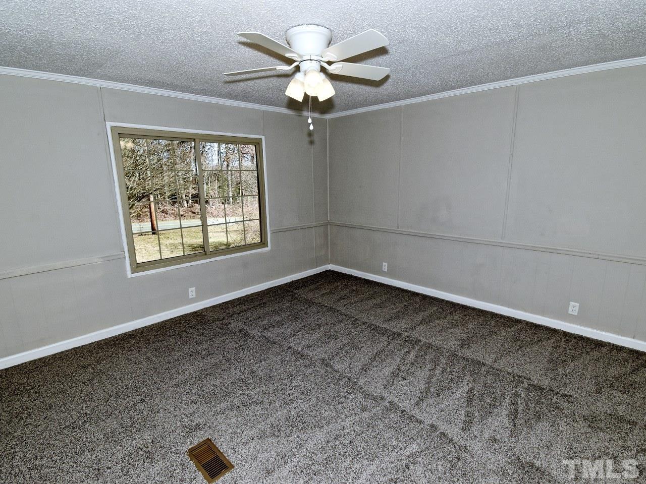 810 Dink Ashley Road Timberlake, NC 27583 - Photo 9 of 31 wooden floor in an empty room with a window