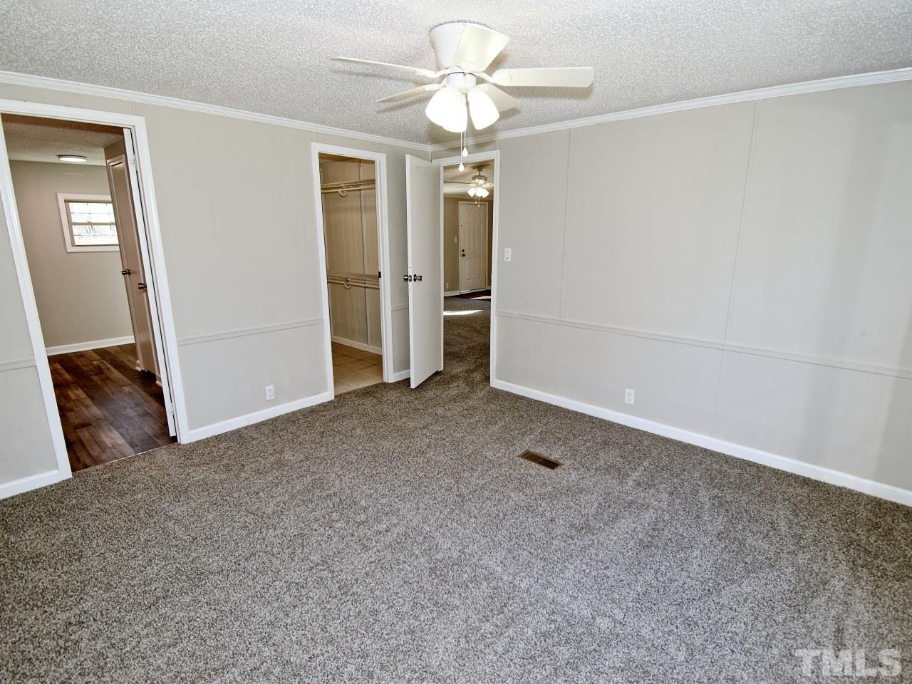 810 Dink Ashley Road Timberlake, NC 27583 - Photo 10 of 31 a view of a chandelier fan in a room