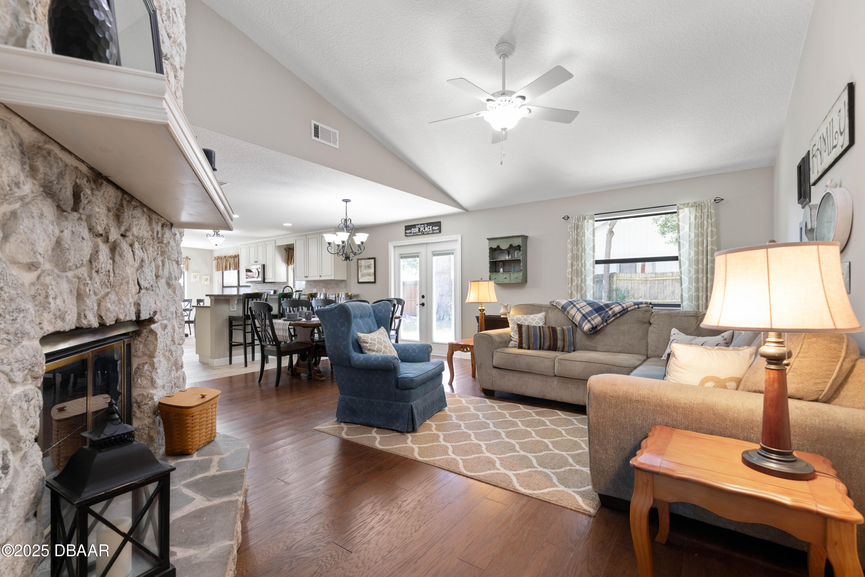 792 Victoria Circle East Ormond Beach, FL 32174 - Photo 11 of 53 a living room with furniture a fireplace and a chandelier