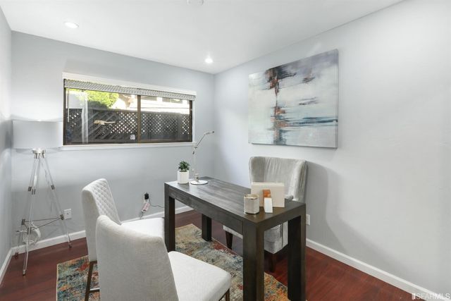 a view of a workspace with furniture and a window