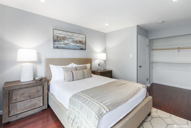 a large bed sitting in a bedroom next to a window