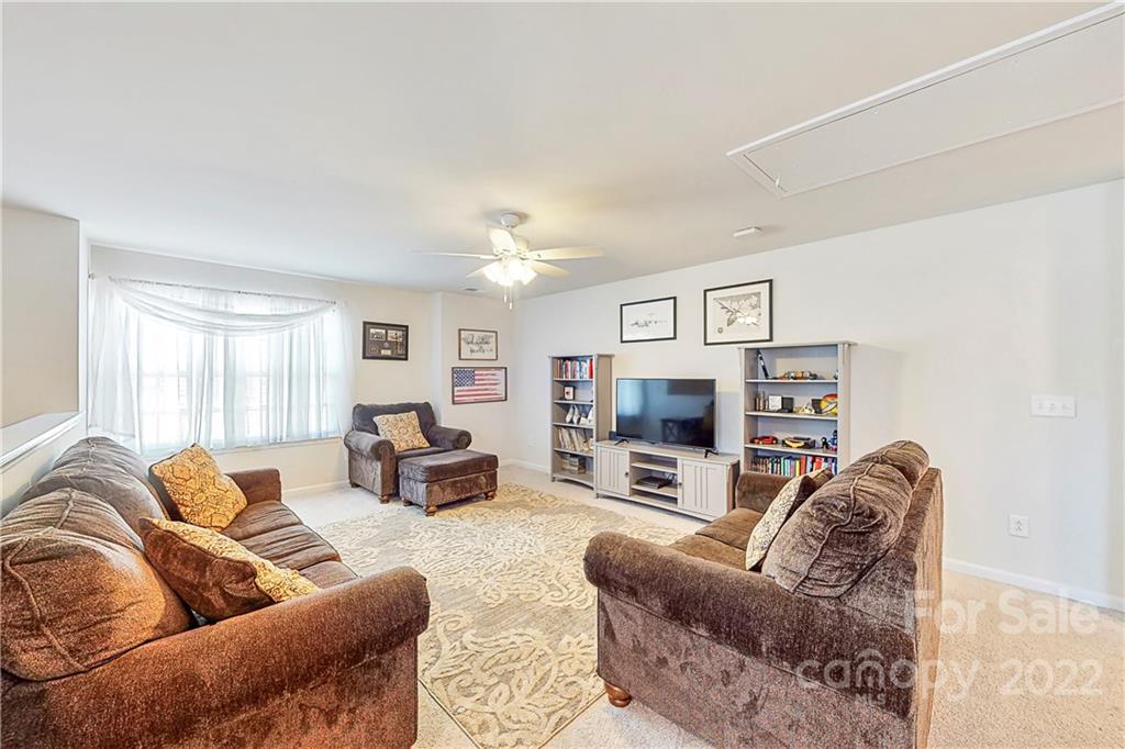 1016 Loggerhead Drive Lancaster, SC 29720 - Photo 19 of 46 a living room with furniture a fireplace and a flat screen tv