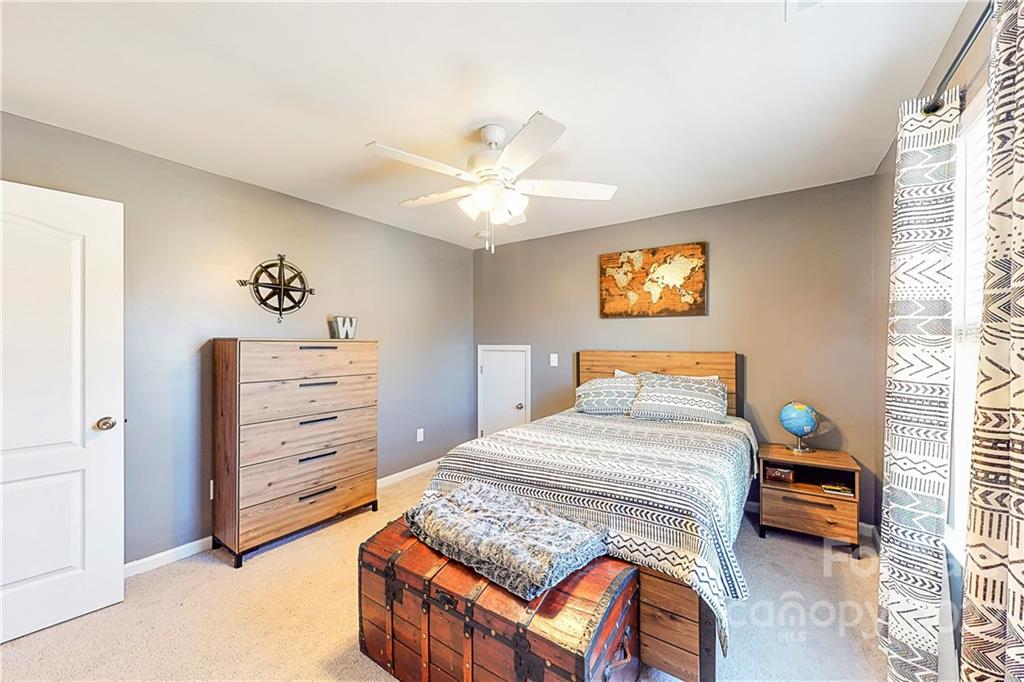 1016 Loggerhead Drive Lancaster, SC 29720 - Photo 21 of 46 a bedroom with a bed and a chandelier