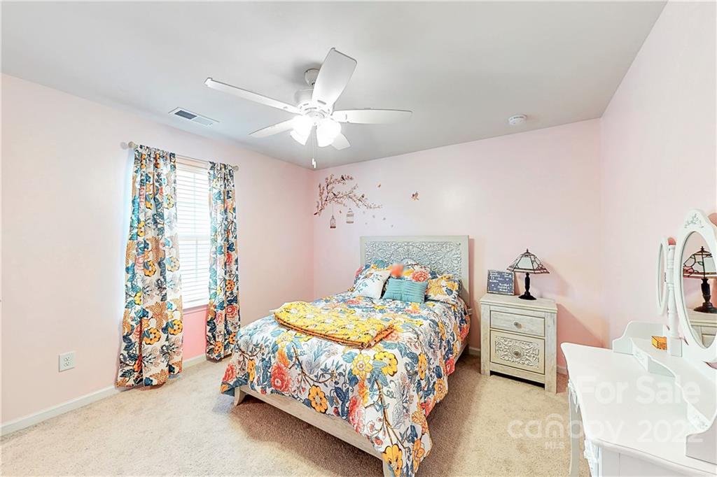 1016 Loggerhead Drive Lancaster, SC 29720 - Photo 23 of 46 a bedroom with a bed and a chandelier