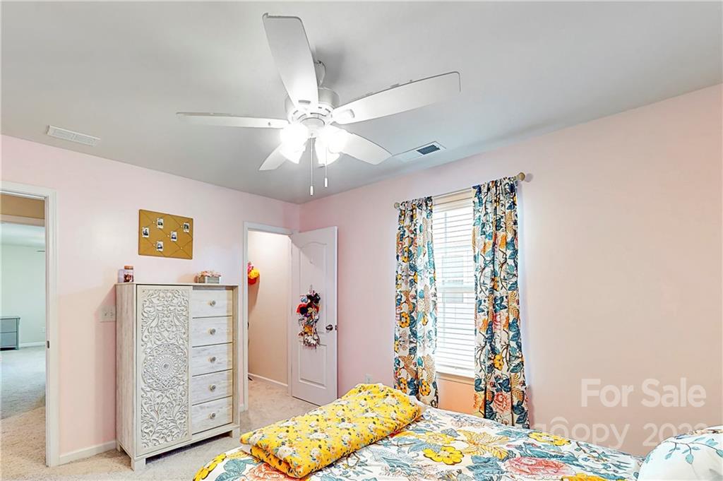 1016 Loggerhead Drive Lancaster, SC 29720 - Photo 24 of 46 a bedroom with a bed and a chandelier