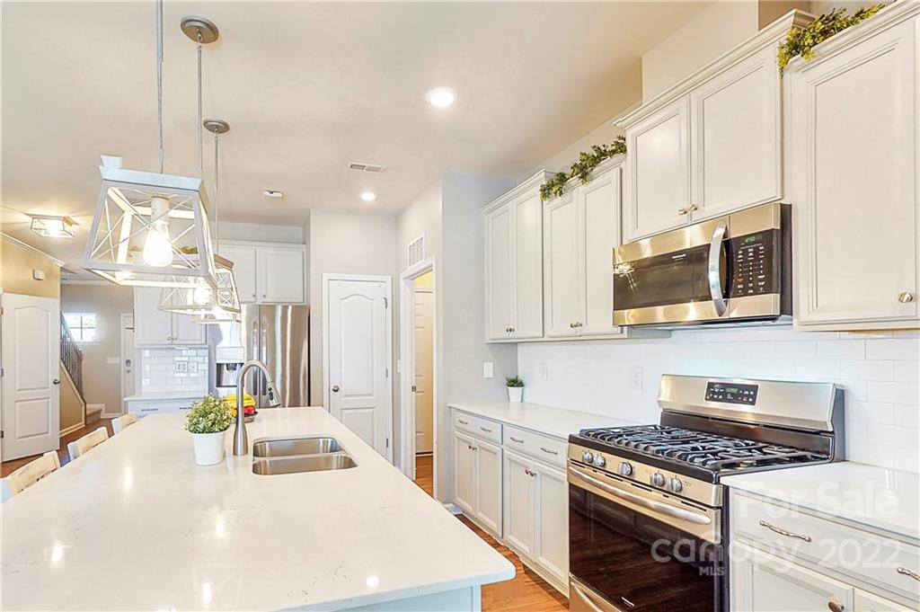 1016 Loggerhead Drive Lancaster, SC 29720 - Photo 5 of 46 a kitchen with stainless steel appliances a stove a sink a microwave and cabinets