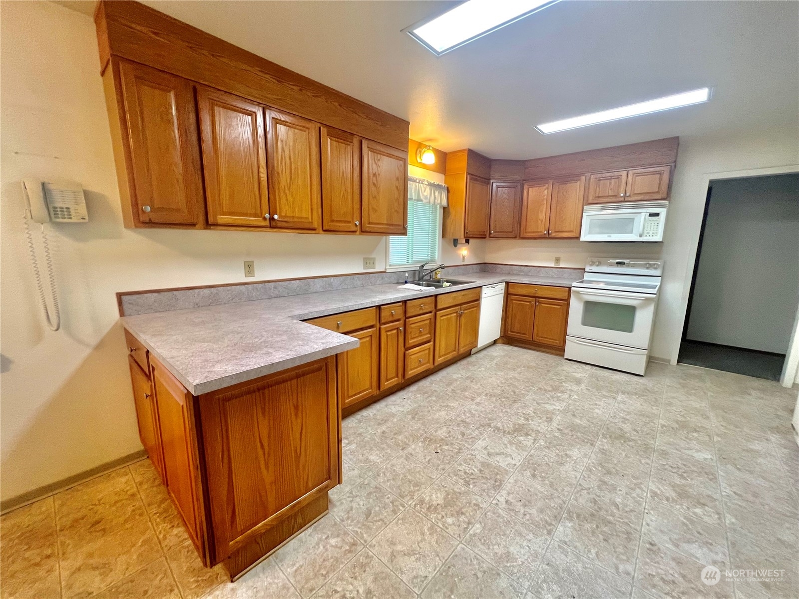 14 Weatherstone Road Omak, WA 98841 - Photo 12 of 32 a kitchen with stainless steel appliances granite countertop a table chairs sink and cabinets