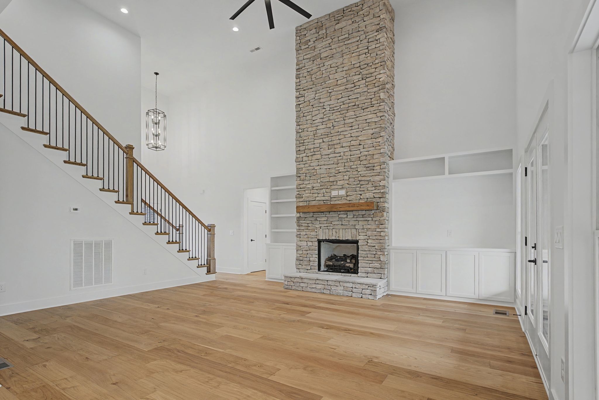 1491 Nonaville Road Mount Juliet, TN 37122 - Photo 19 of 60 a view of an empty room with wooden floor and a fireplace