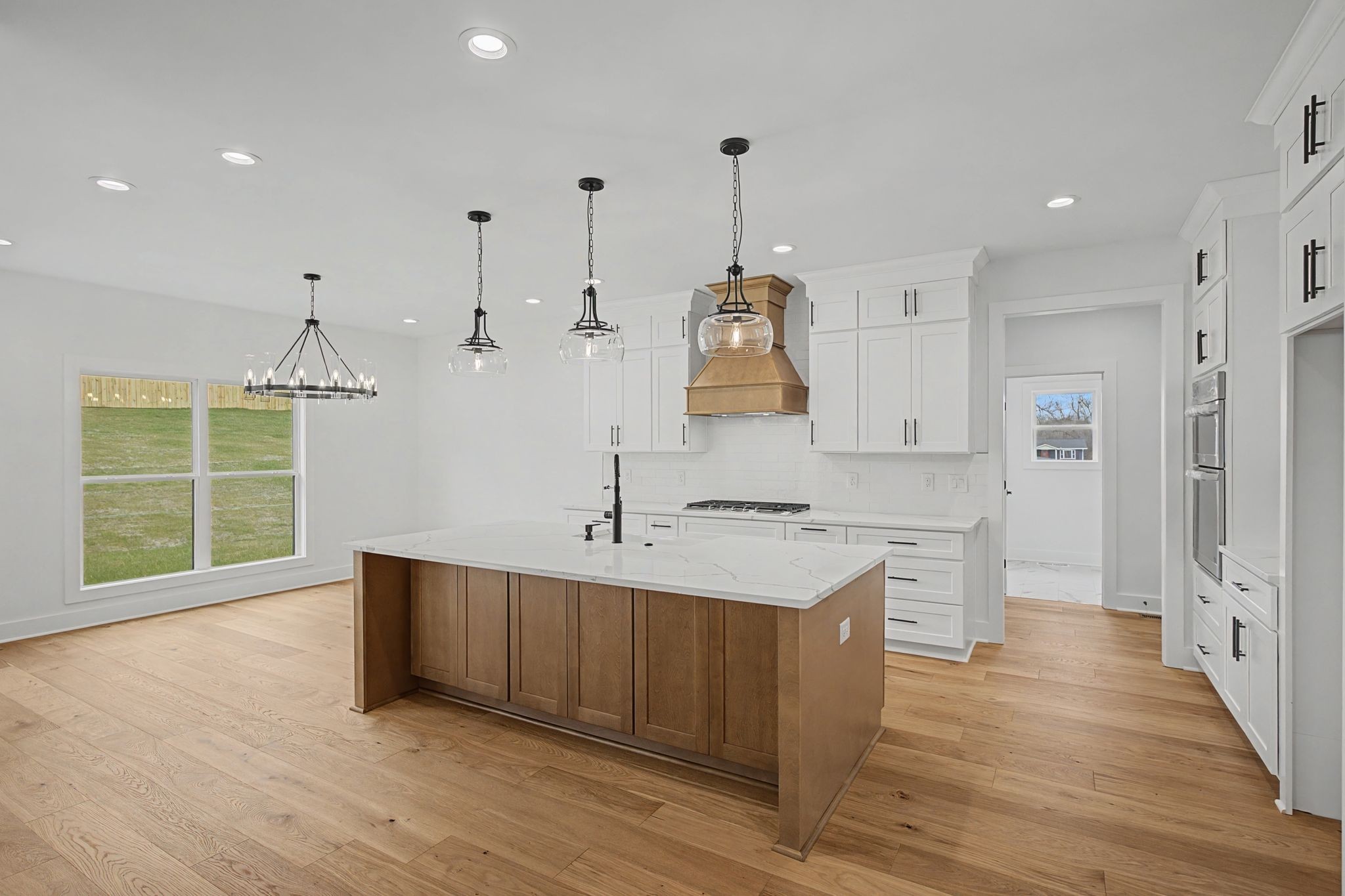 1491 Nonaville Road Mount Juliet, TN 37122 - Photo 20 of 60 a large kitchen with stainless steel appliances a large counter top a sink a refrigerator and a stove