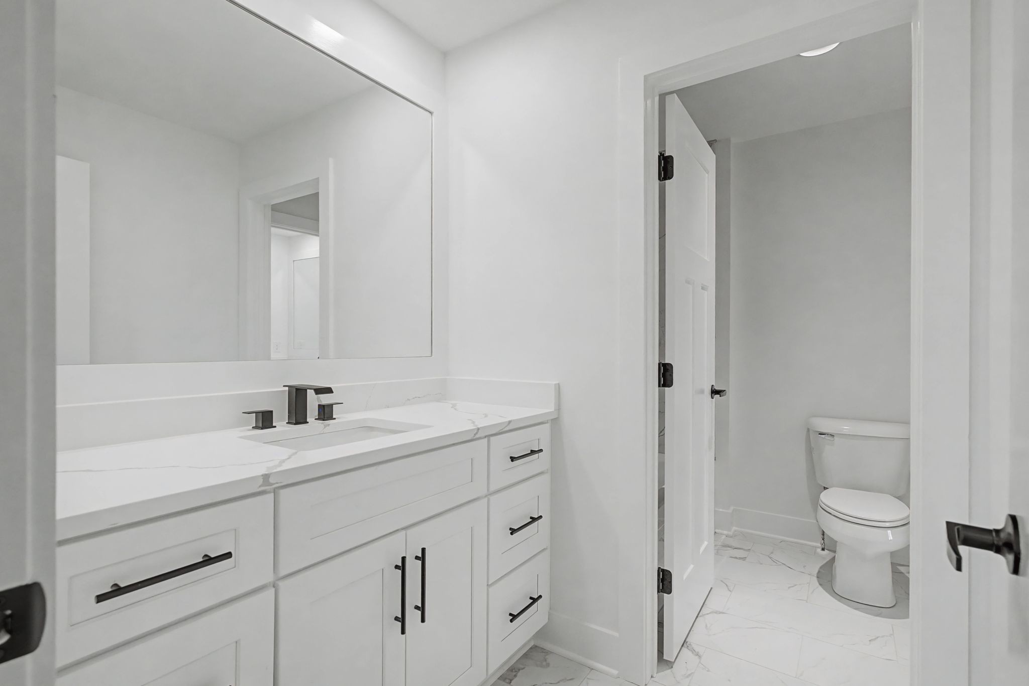 1491 Nonaville Road Mount Juliet, TN 37122 - Photo 43 of 60 a bathroom with a toilet a sink a mirror and vanity