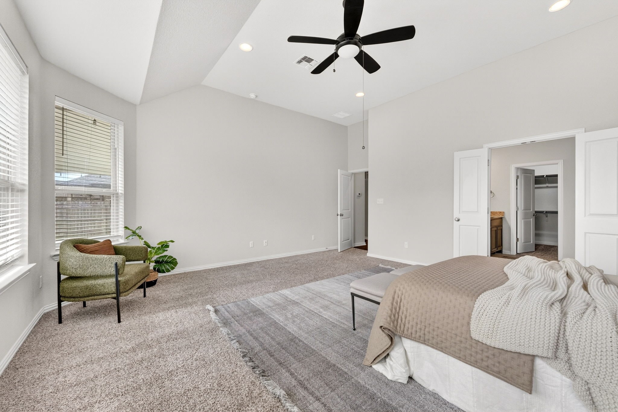 12613 Twisted Root Drive Manchaca, TX 78652 - Photo 12 of 32 a bedroom with a bed a couch and a window