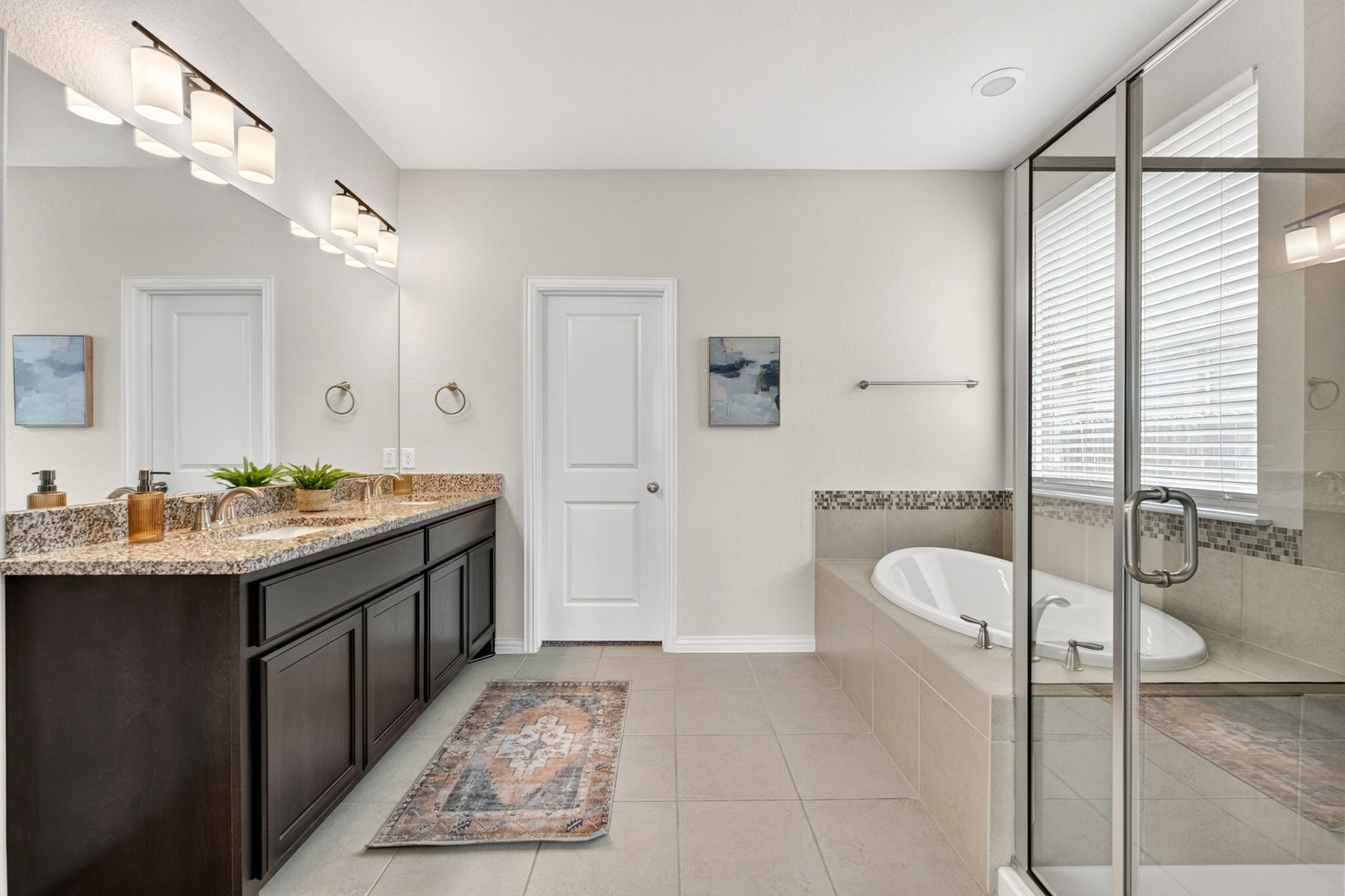 12613 Twisted Root Drive Manchaca, TX 78652 - Photo 13 of 32 a spacious bathroom with a granite countertop sink and a mirror