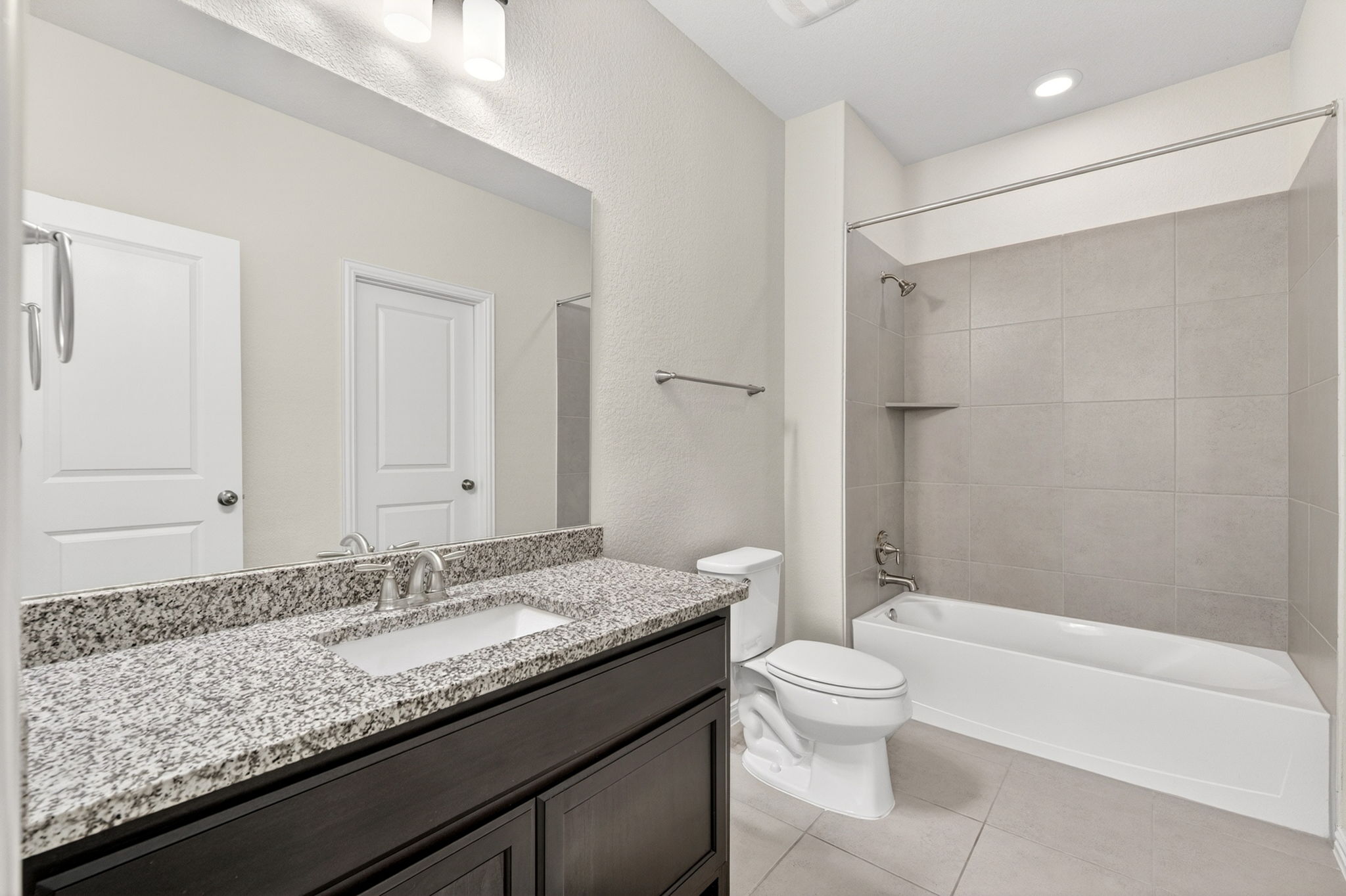 12613 Twisted Root Drive Manchaca, TX 78652 - Photo 16 of 32 a bathroom with a granite countertop sink a toilet and shower