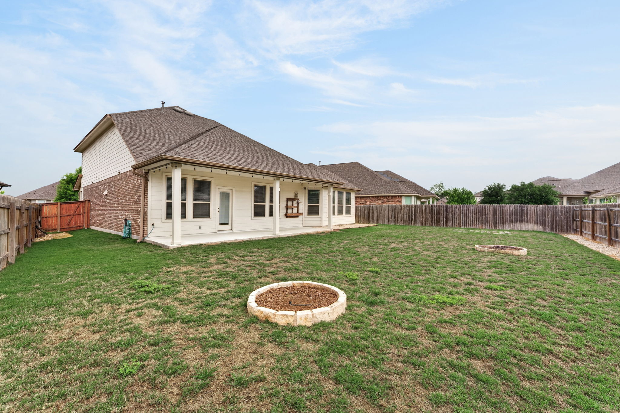 12613 Twisted Root Drive Manchaca, TX 78652 - Photo 24 of 32 a view of a house with a backyard