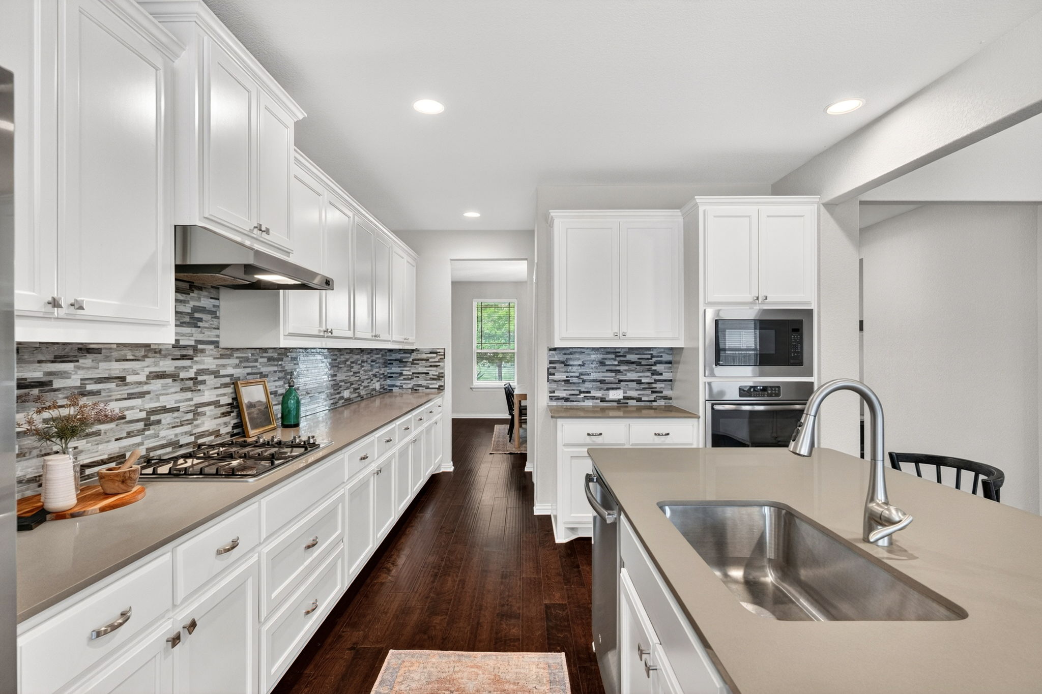 12613 Twisted Root Drive Manchaca, TX 78652 - Photo 8 of 32 a kitchen with stainless steel appliances sink a stove and cabinets