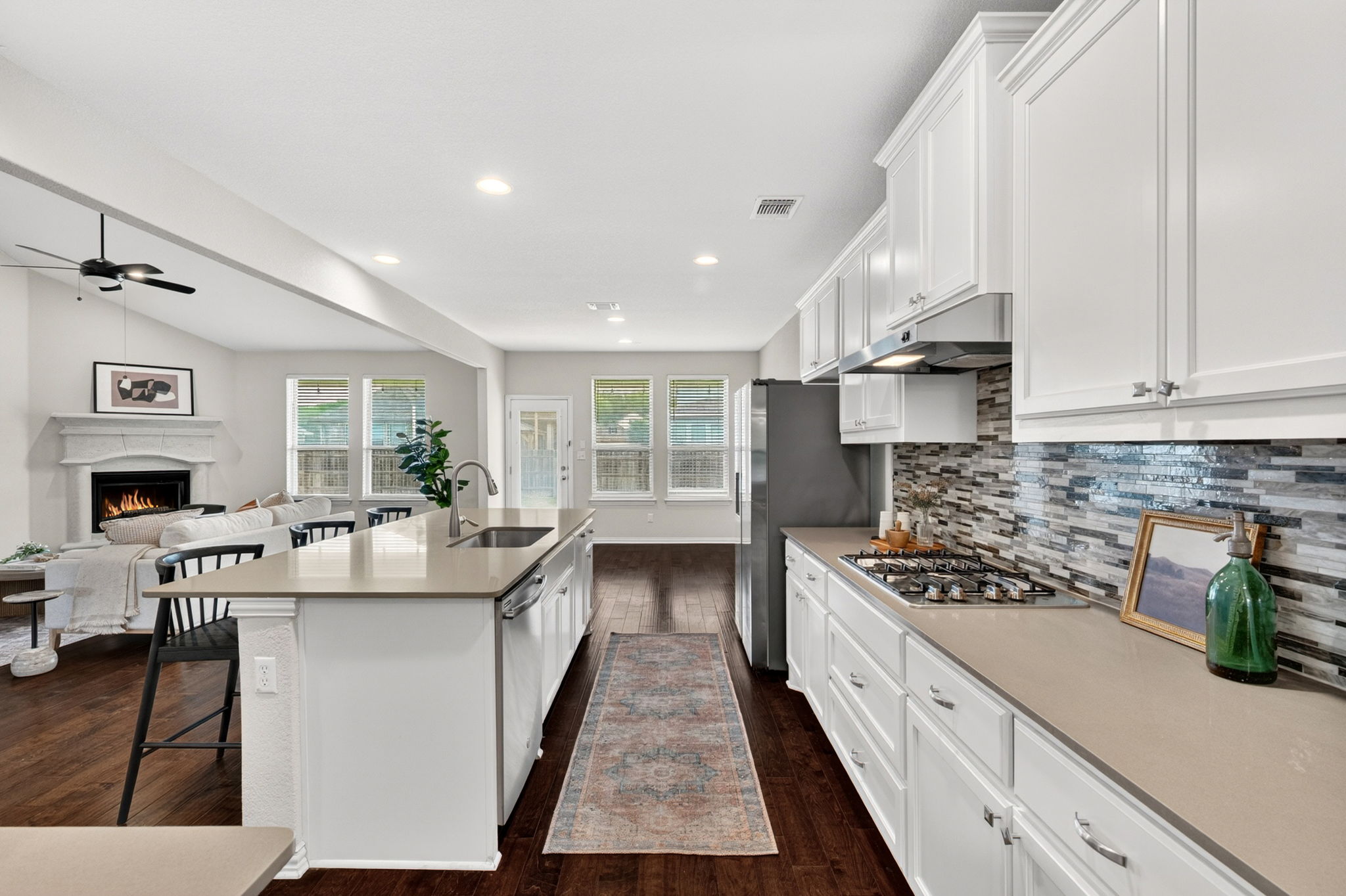 12613 Twisted Root Drive Manchaca, TX 78652 - Photo 9 of 32 a kitchen with stainless steel appliances granite countertop a sink stove and cabinets