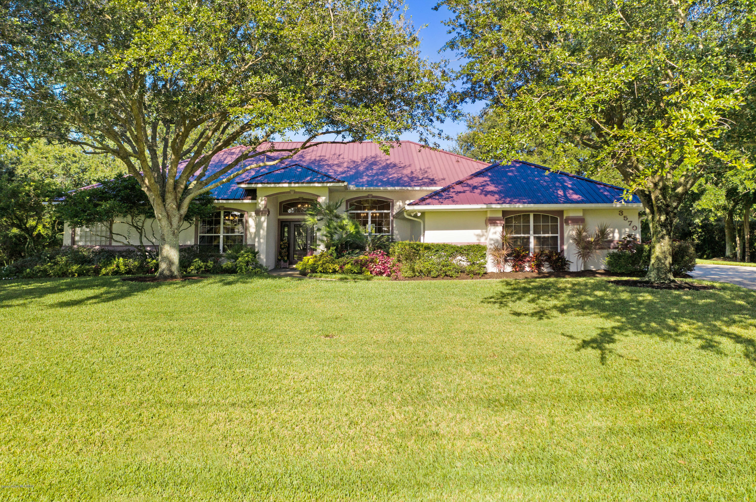 3570 Shady Run Road Melbourne, FL 32934 - Photo 2 of 39 a front view of a house with swimming pool
