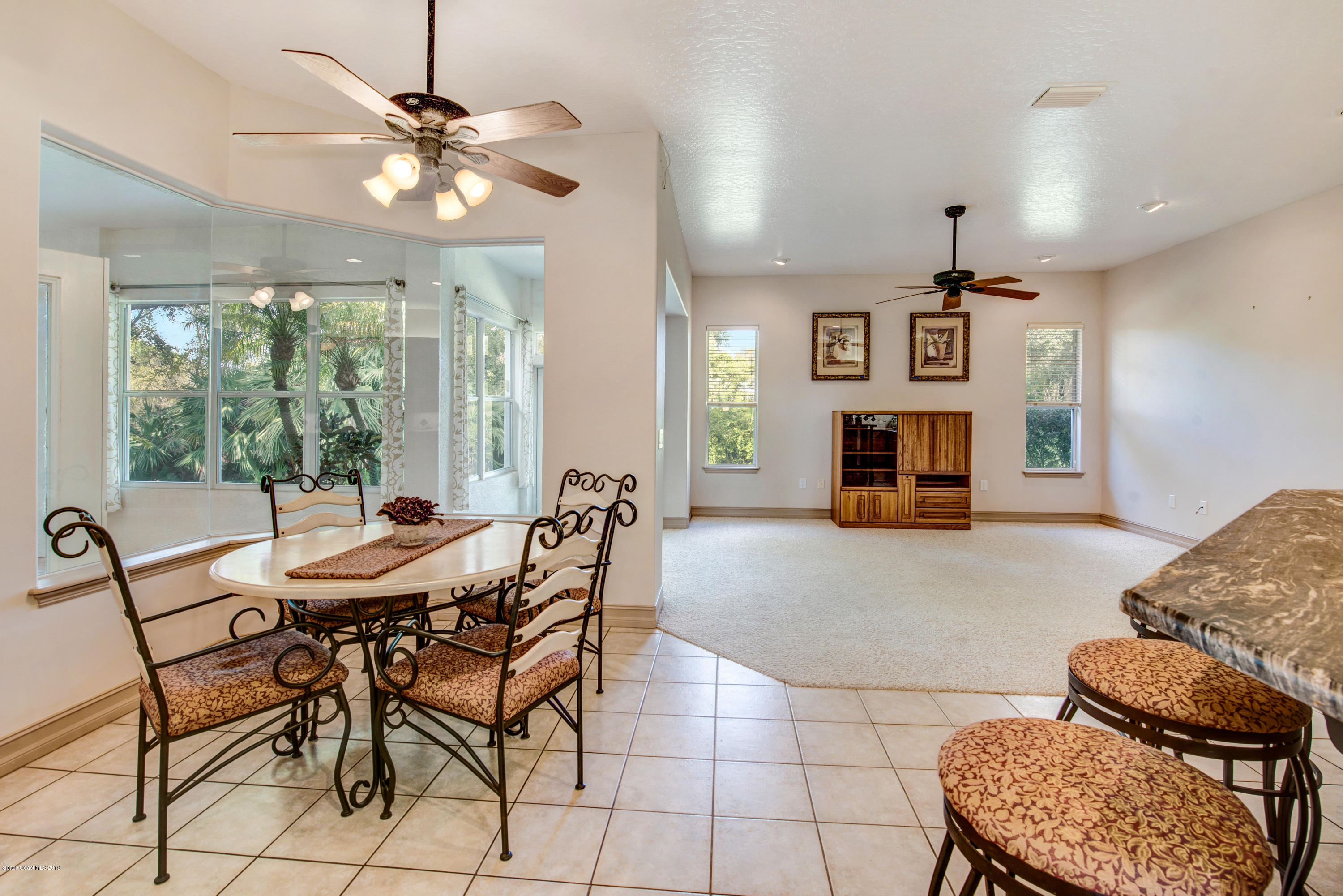 3570 Shady Run Road Melbourne, FL 32934 - Photo 14 of 39 a dining room with furniture and window