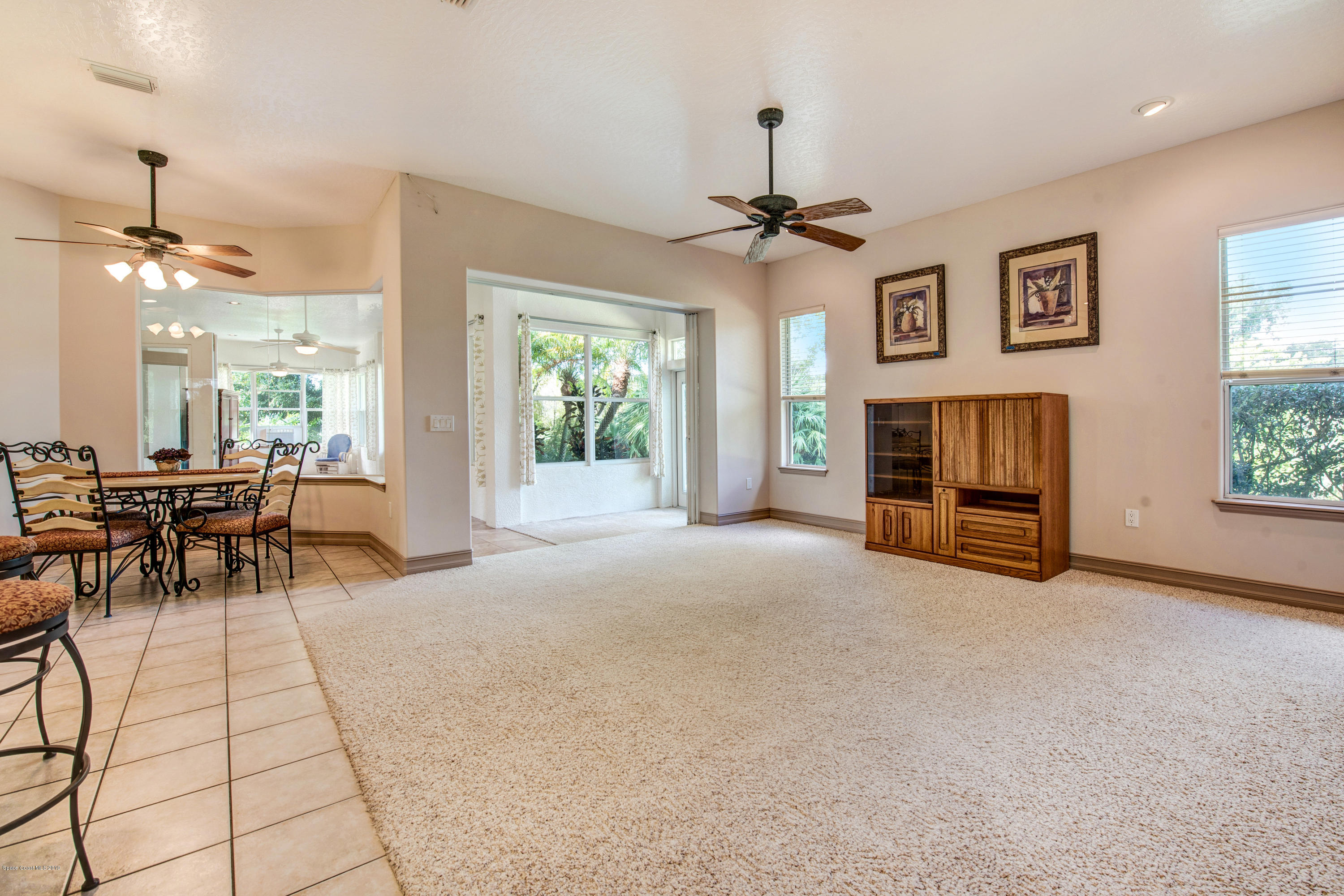 3570 Shady Run Road Melbourne, FL 32934 - Photo 15 of 39 a view of a livingroom with furniture and a ceiling fan