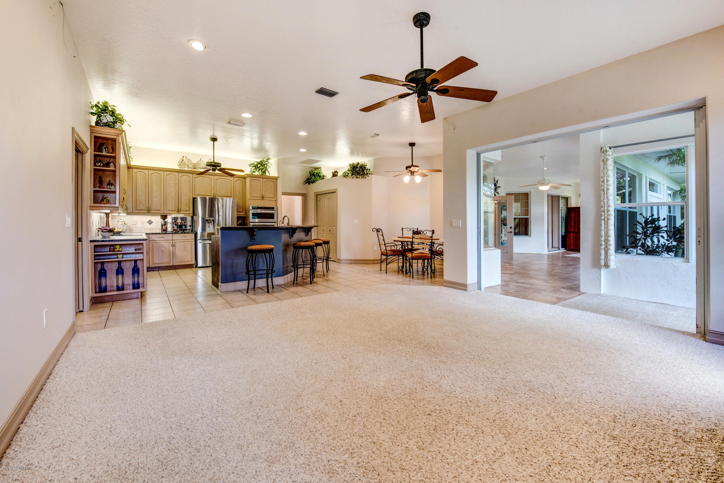 3570 Shady Run Road Melbourne, FL 32934 - Photo 16 of 39 a view of a livingroom with furniture and a ceiling fan