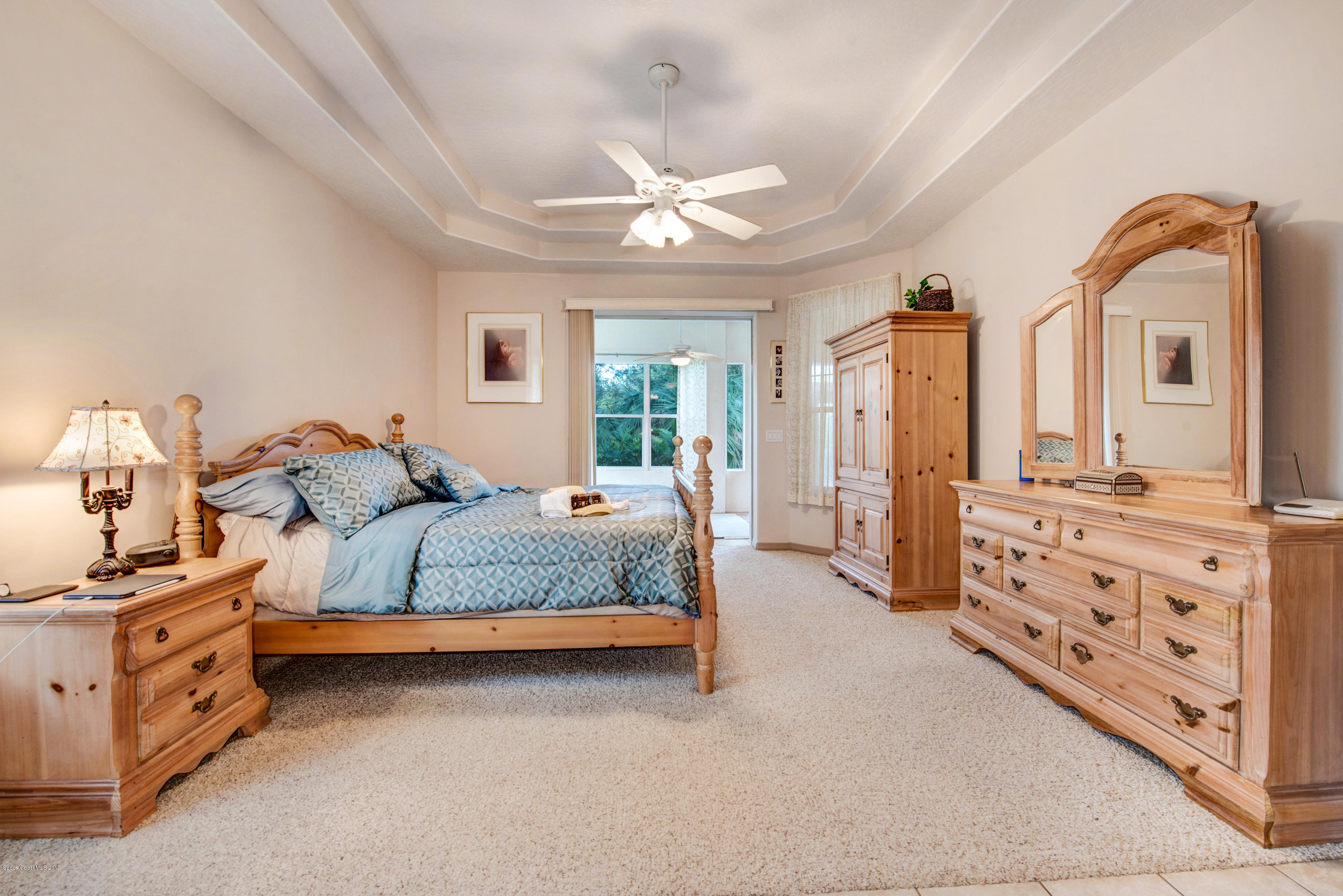 3570 Shady Run Road Melbourne, FL 32934 - Photo 21 of 39 a spacious bedroom with two beds and ceiling fan