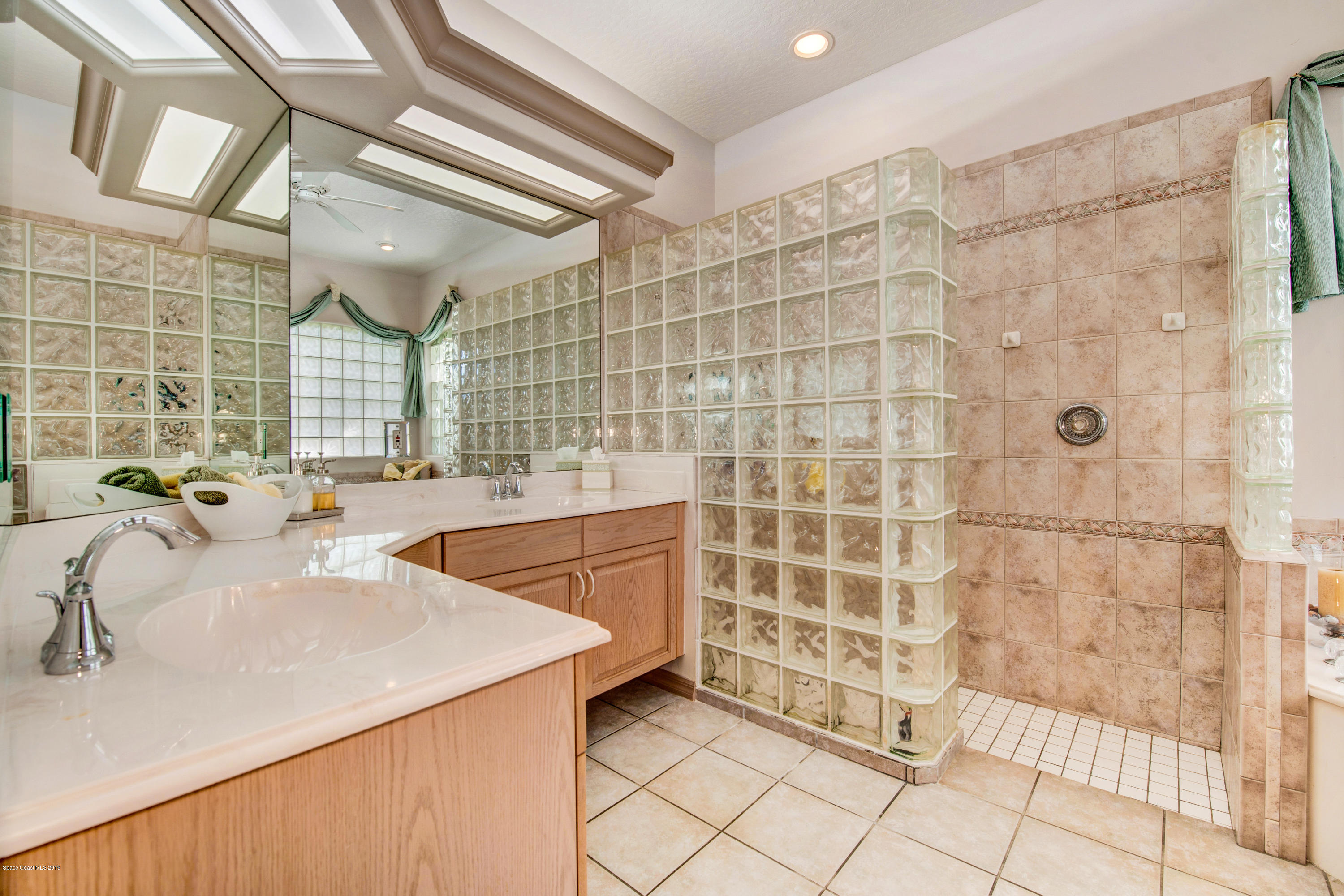 3570 Shady Run Road Melbourne, FL 32934 - Photo 22 of 39 a bathroom with a sink and a shower