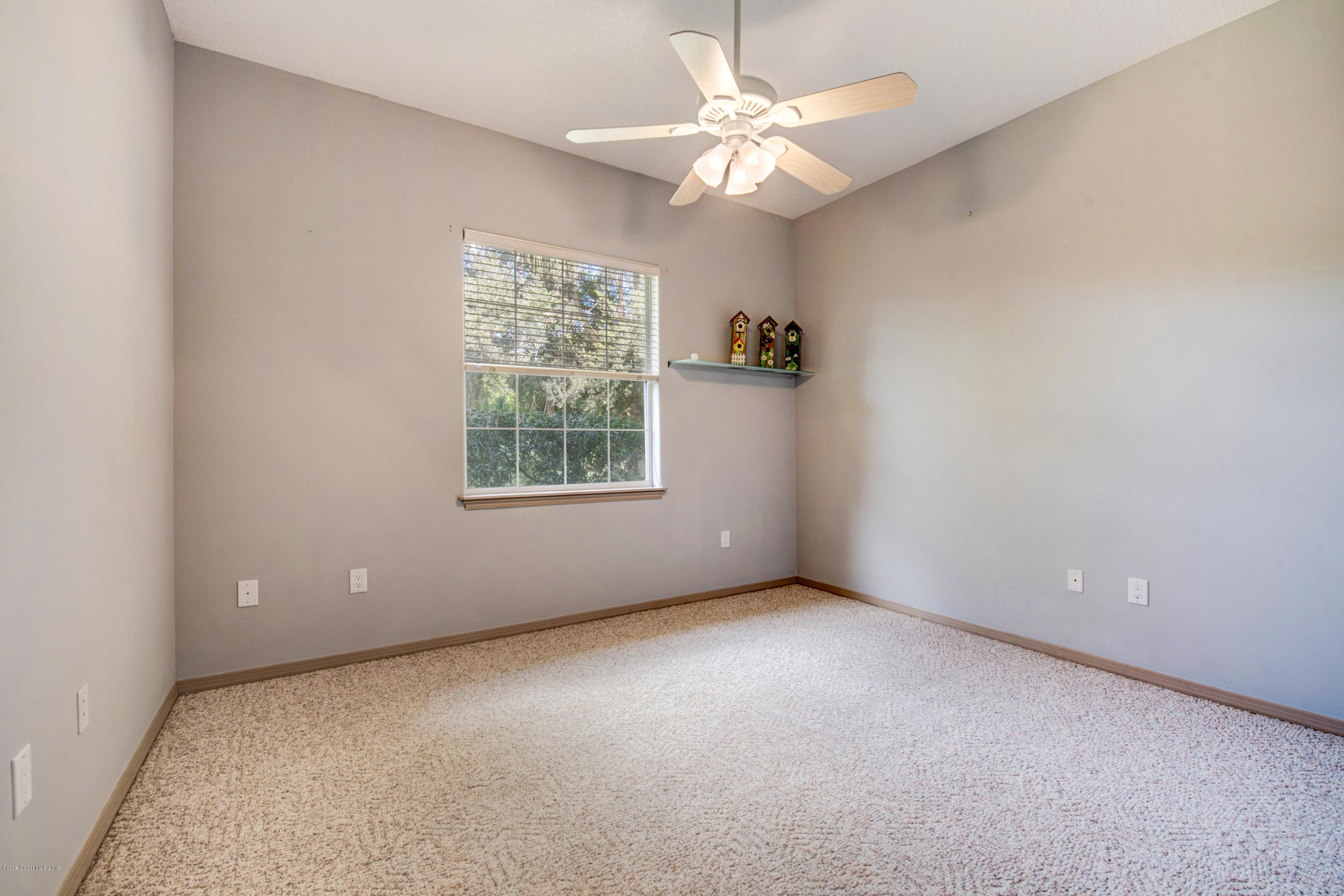 3570 Shady Run Road Melbourne, FL 32934 - Photo 25 of 39 an empty room with a window and a fan