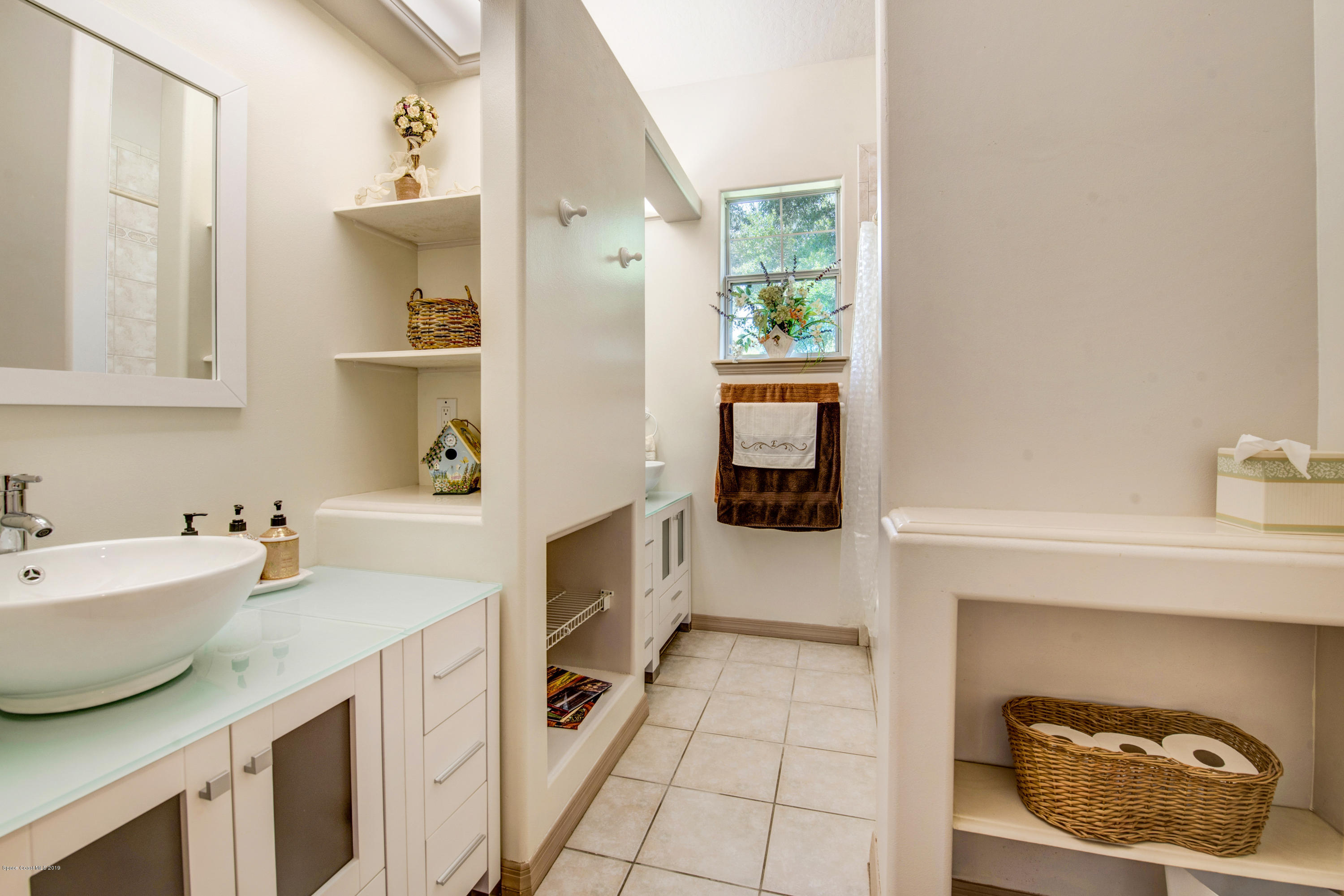 3570 Shady Run Road Melbourne, FL 32934 - Photo 26 of 39 a kitchen with a sink and a stove with white walls