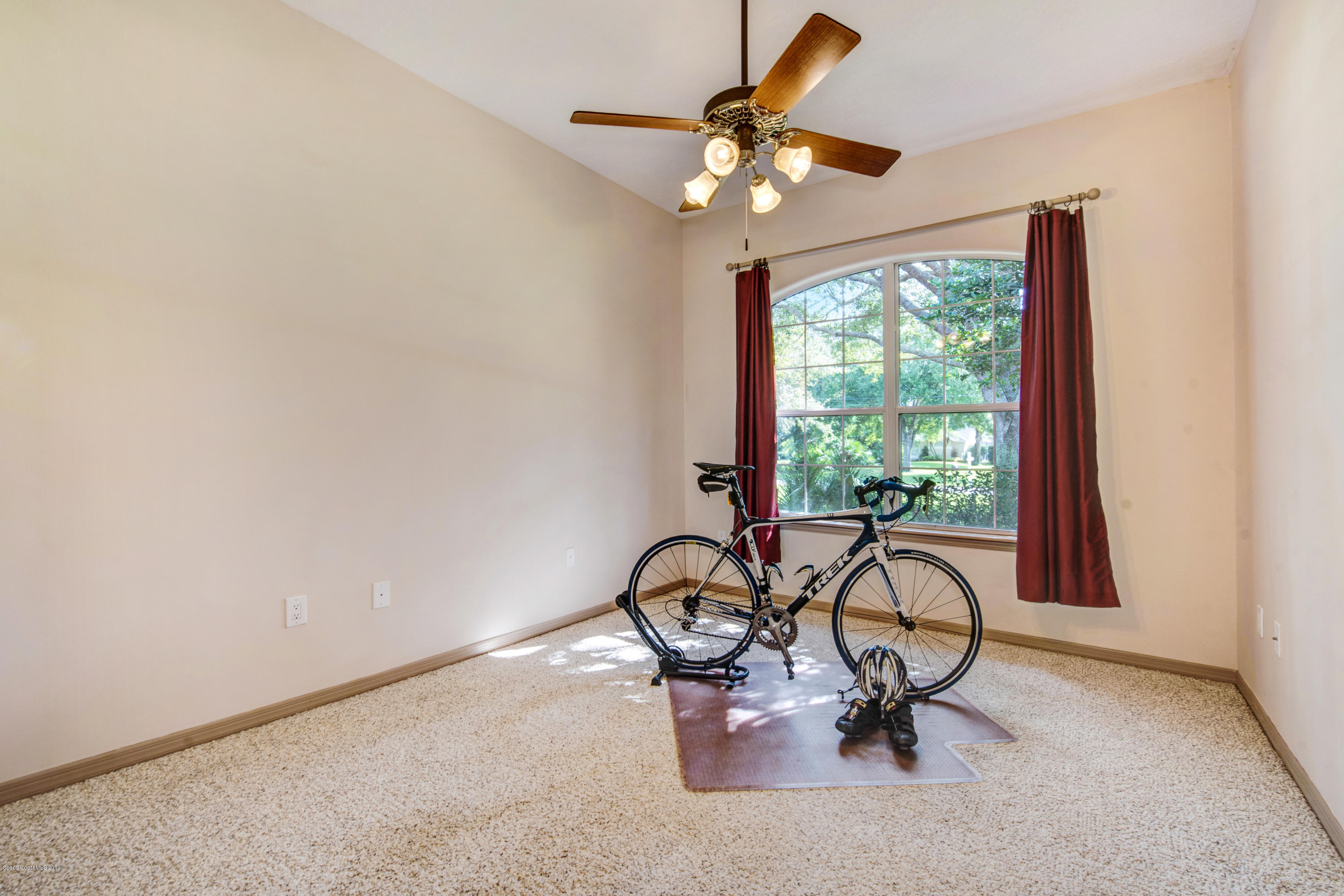3570 Shady Run Road Melbourne, FL 32934 - Photo 29 of 39 a view of a room with gym equipment and windows