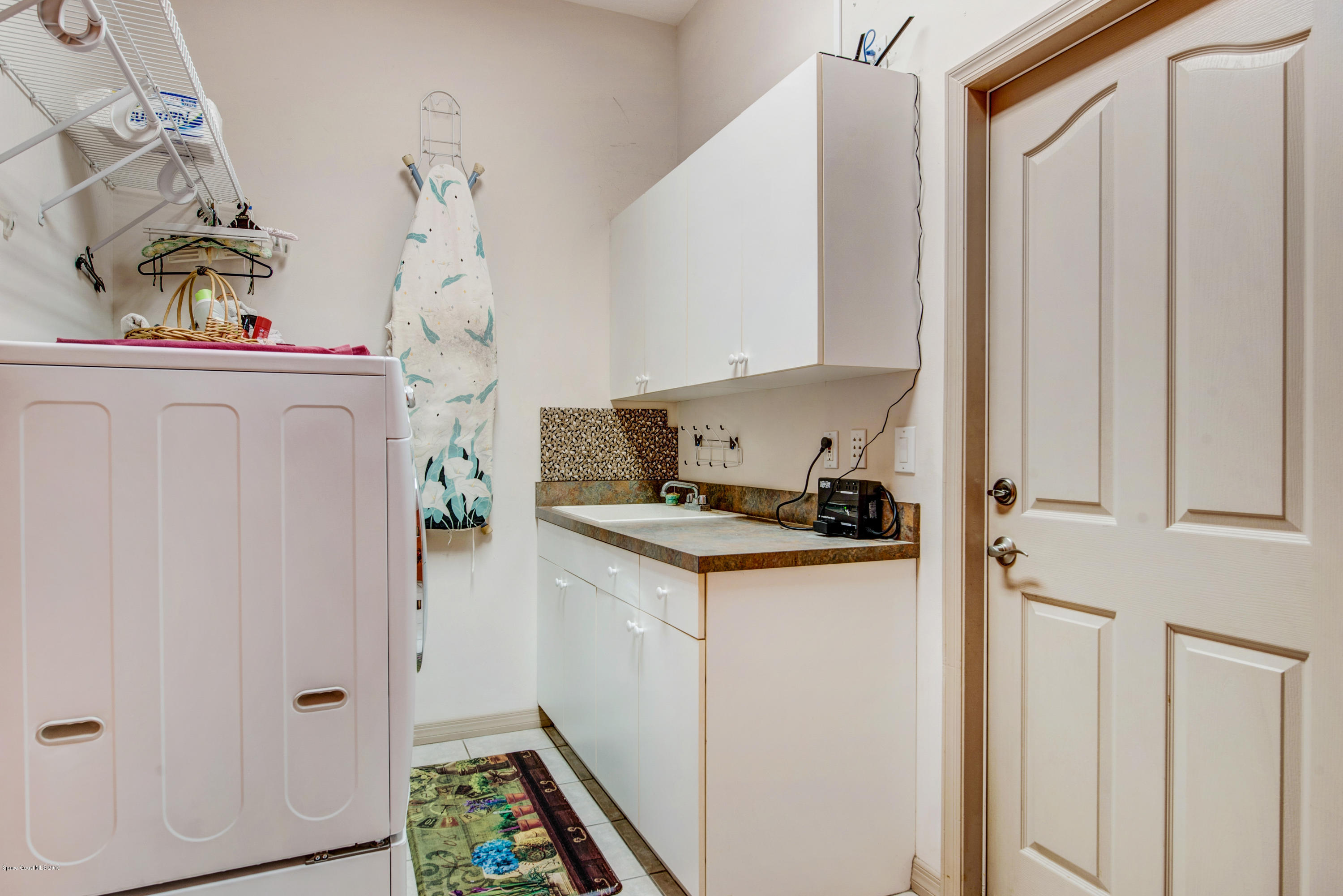 3570 Shady Run Road Melbourne, FL 32934 - Photo 30 of 39 a kitchen with stainless steel appliances granite countertop a refrigerator and a stove