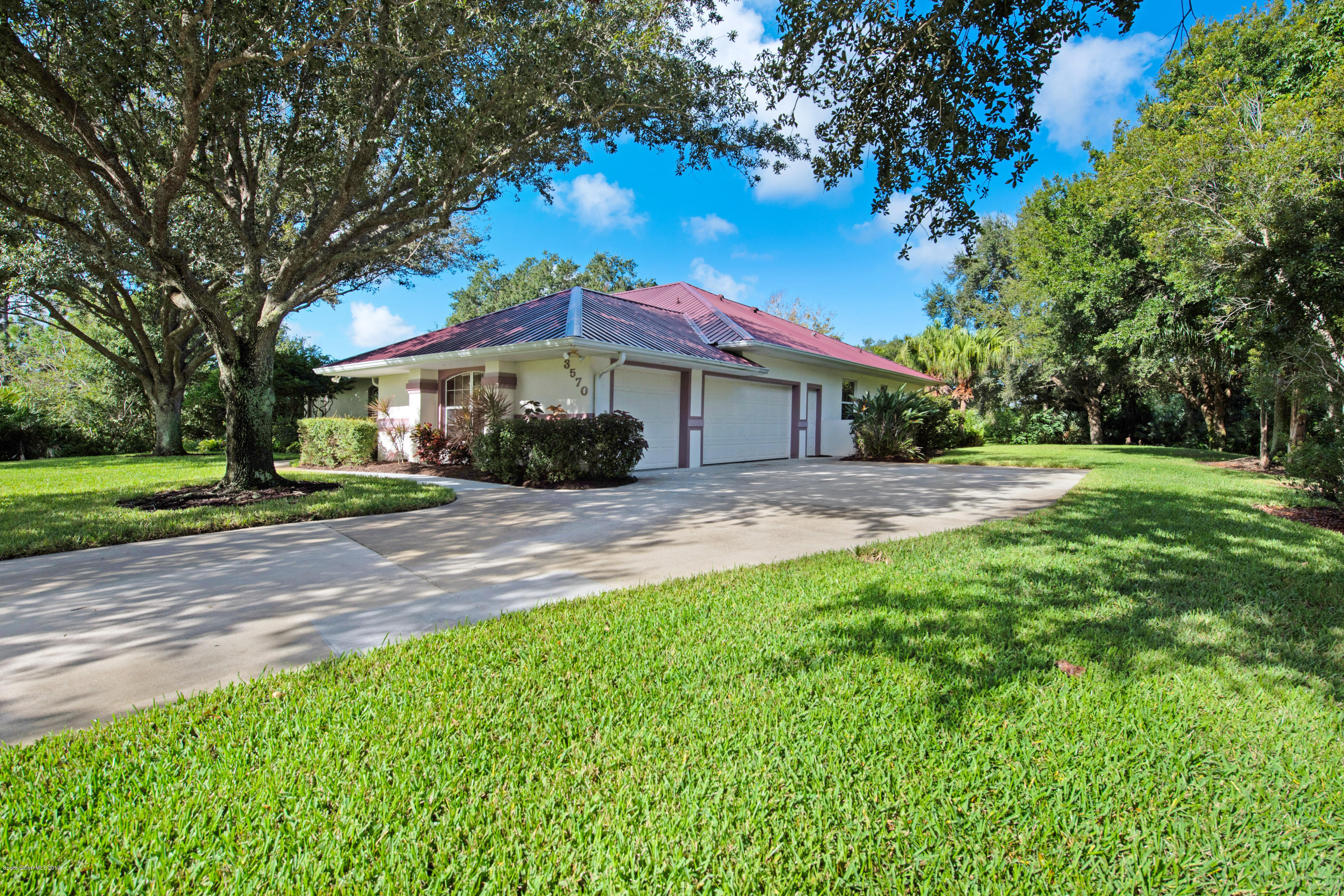 3570 Shady Run Road Melbourne, FL 32934 - Photo 4 of 39 a front view of a house with a yard