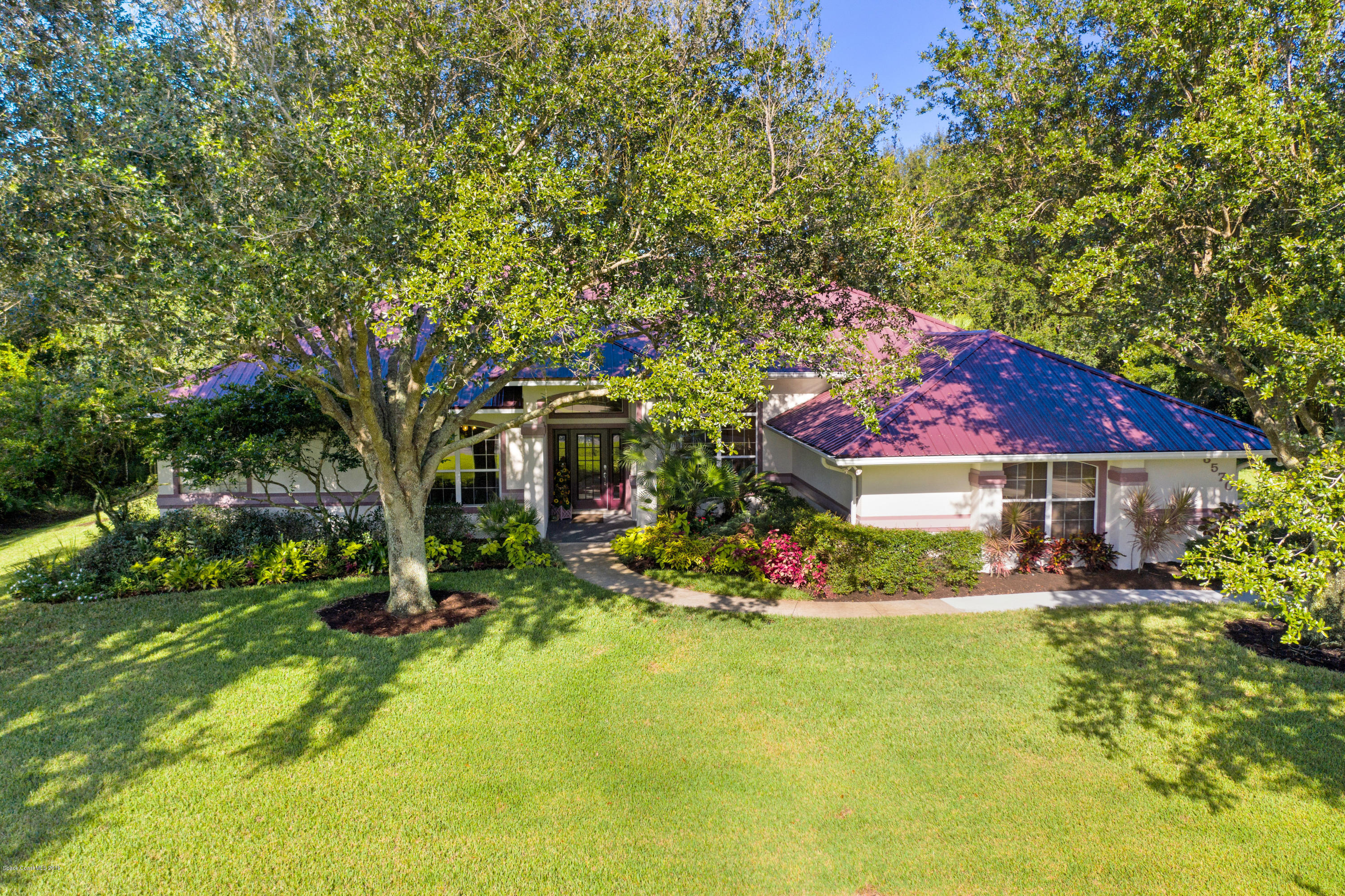 3570 Shady Run Road Melbourne, FL 32934 - Photo 32 of 39 a front view of a house with yard