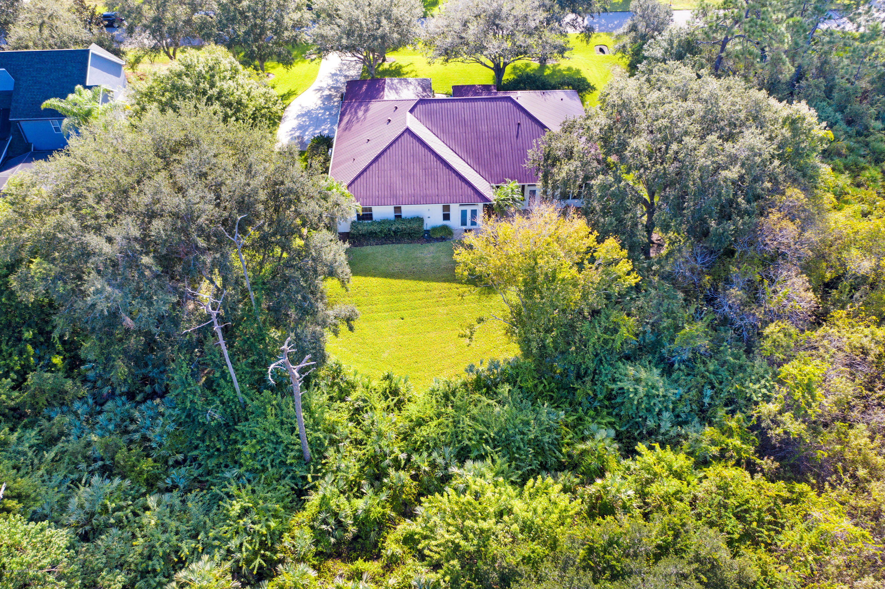 3570 Shady Run Road Melbourne, FL 32934 - Photo 34 of 39 a view of a house with a swimming pool and a yard