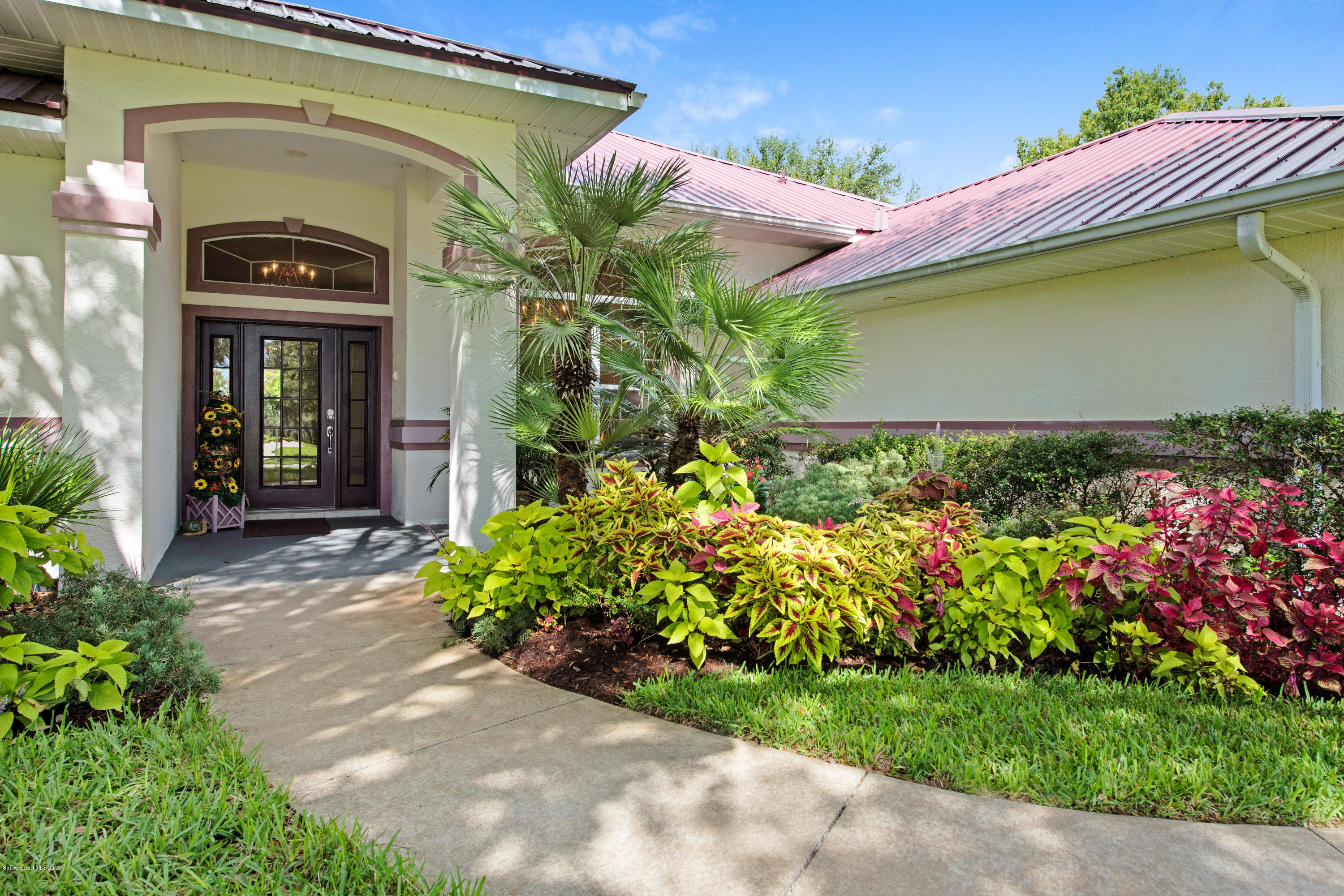 3570 Shady Run Road Melbourne, FL 32934 - Photo 5 of 39 a front view of a house with a yard