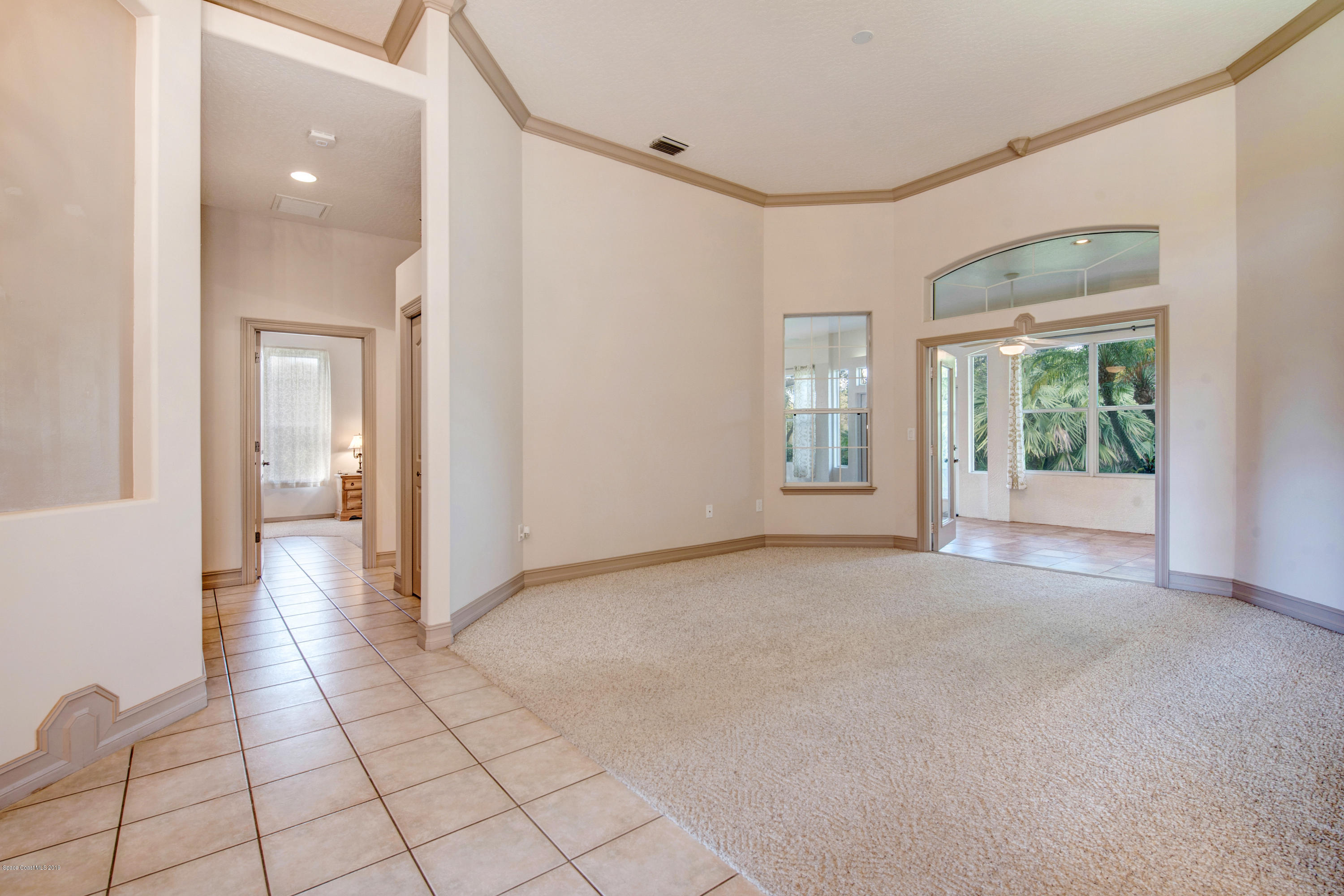 3570 Shady Run Road Melbourne, FL 32934 - Photo 7 of 39 a view of a hallway with wooden floor and a living room
