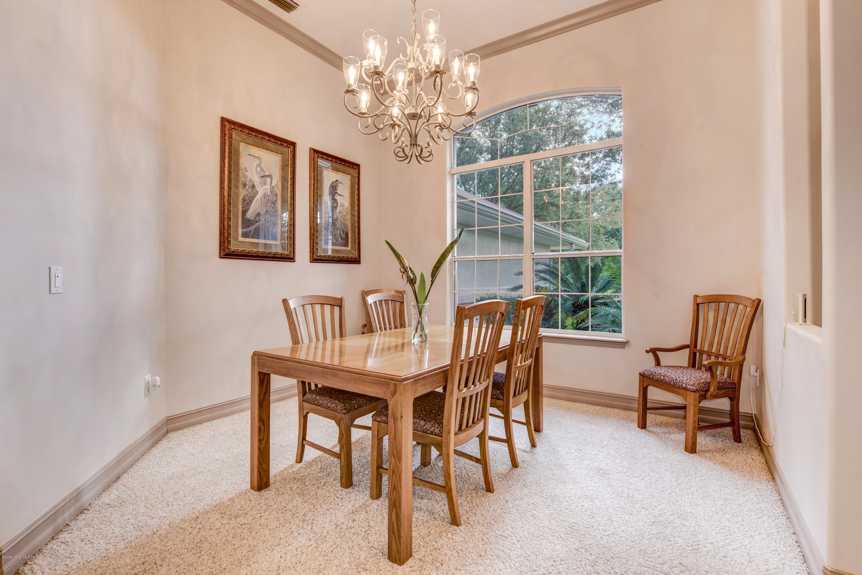 3570 Shady Run Road Melbourne, FL 32934 - Photo 8 of 39 a view of a dining room with furniture window and outside view