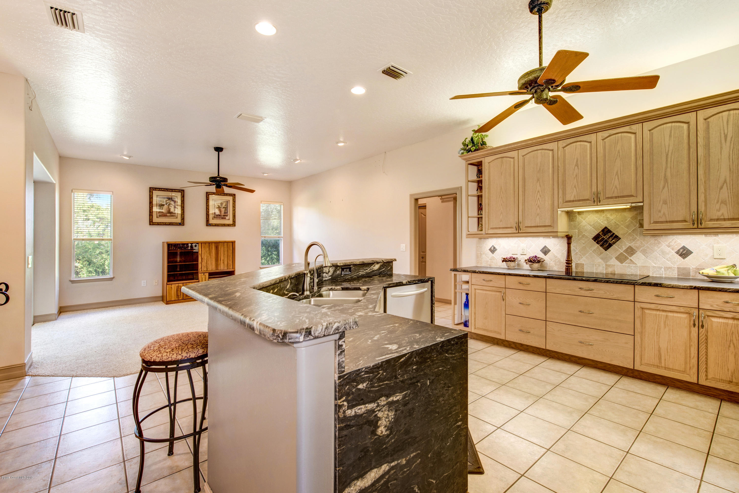 3570 Shady Run Road Melbourne, FL 32934 - Photo 10 of 39 a kitchen with sink cabinets and window