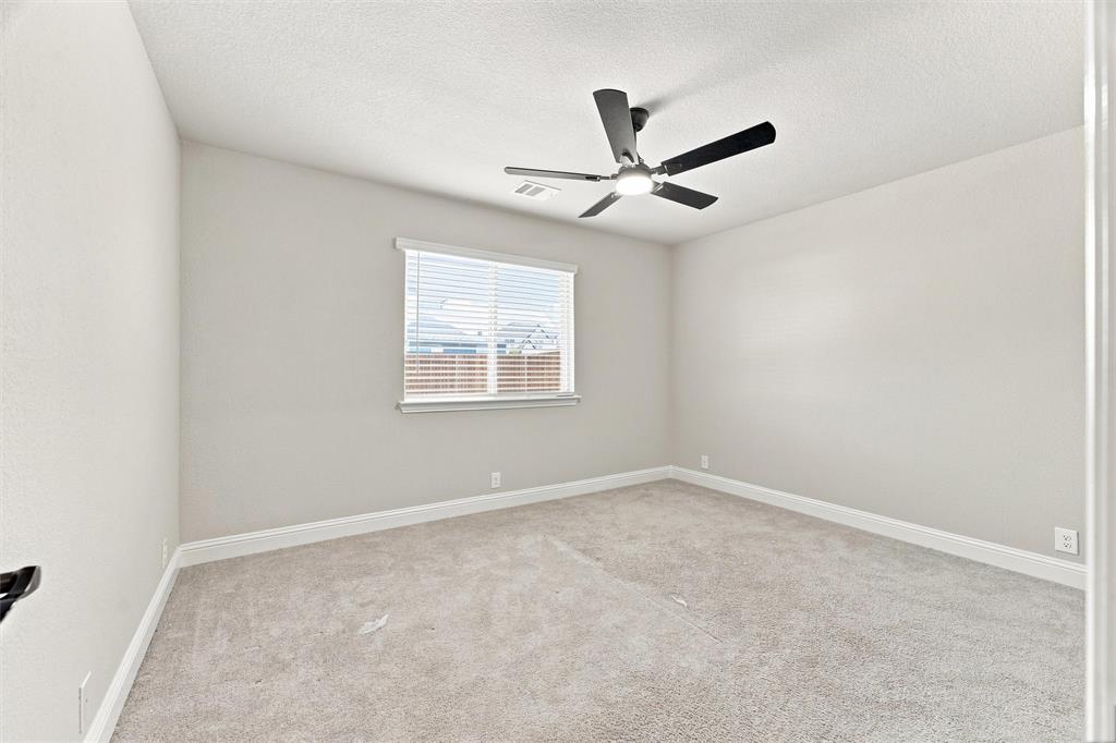 5225 Rowlan Row Midlothian, TX 76065 - Photo 23 of 33 Neutral tone wall paint, carpeted flooring, window with blinds, and ceiling fan with integrated lighting
