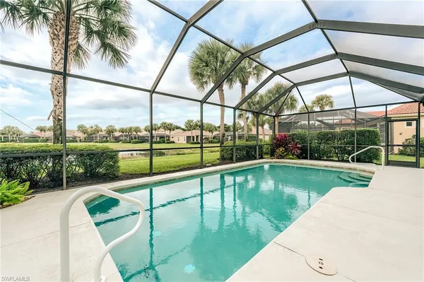 a view of a swimming pool with a patio and a garden
