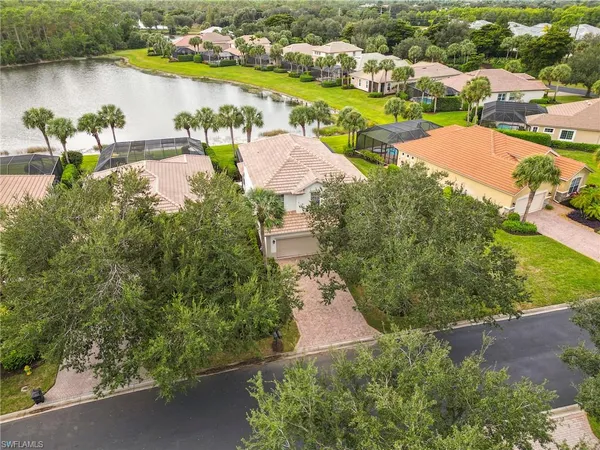 an aerial view of residential houses with outdoor space and lake view