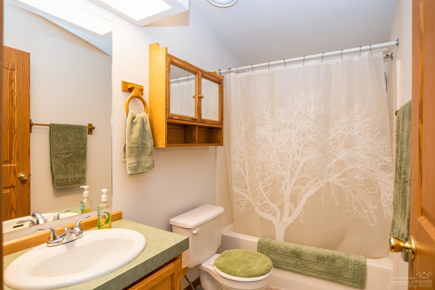 19047 Choctaw Road Bend, OR 97702 - Photo 11 of 23 a bathroom with a sink toilet and shower