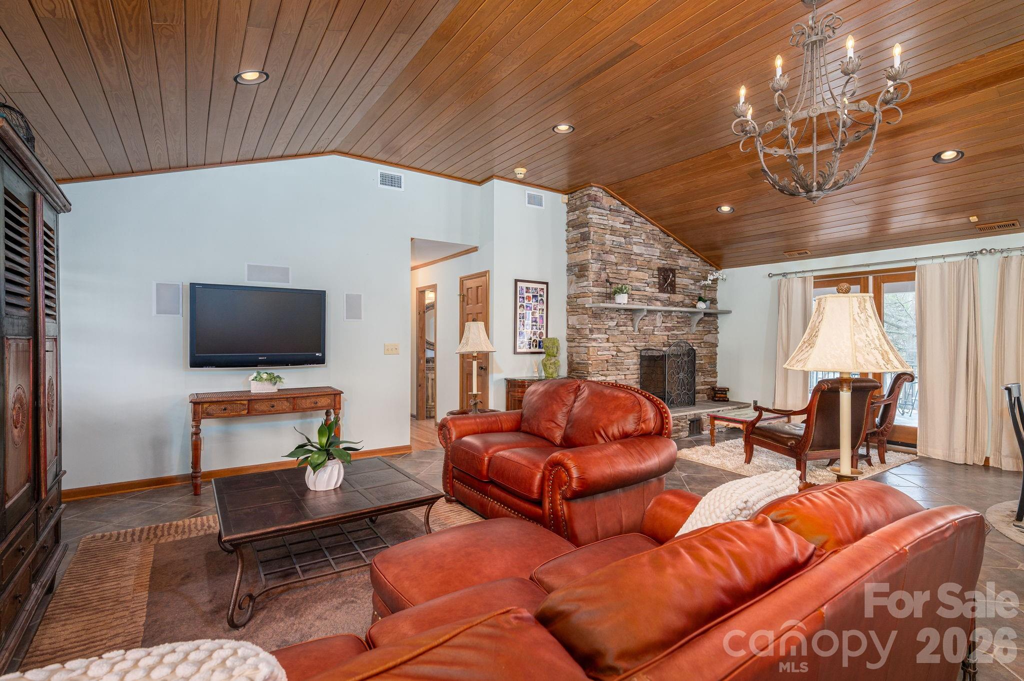 872 Armstrong Road Belmont, NC 28012 - Photo 21 of 48 a living room with furniture a flat screen tv and a chandelier