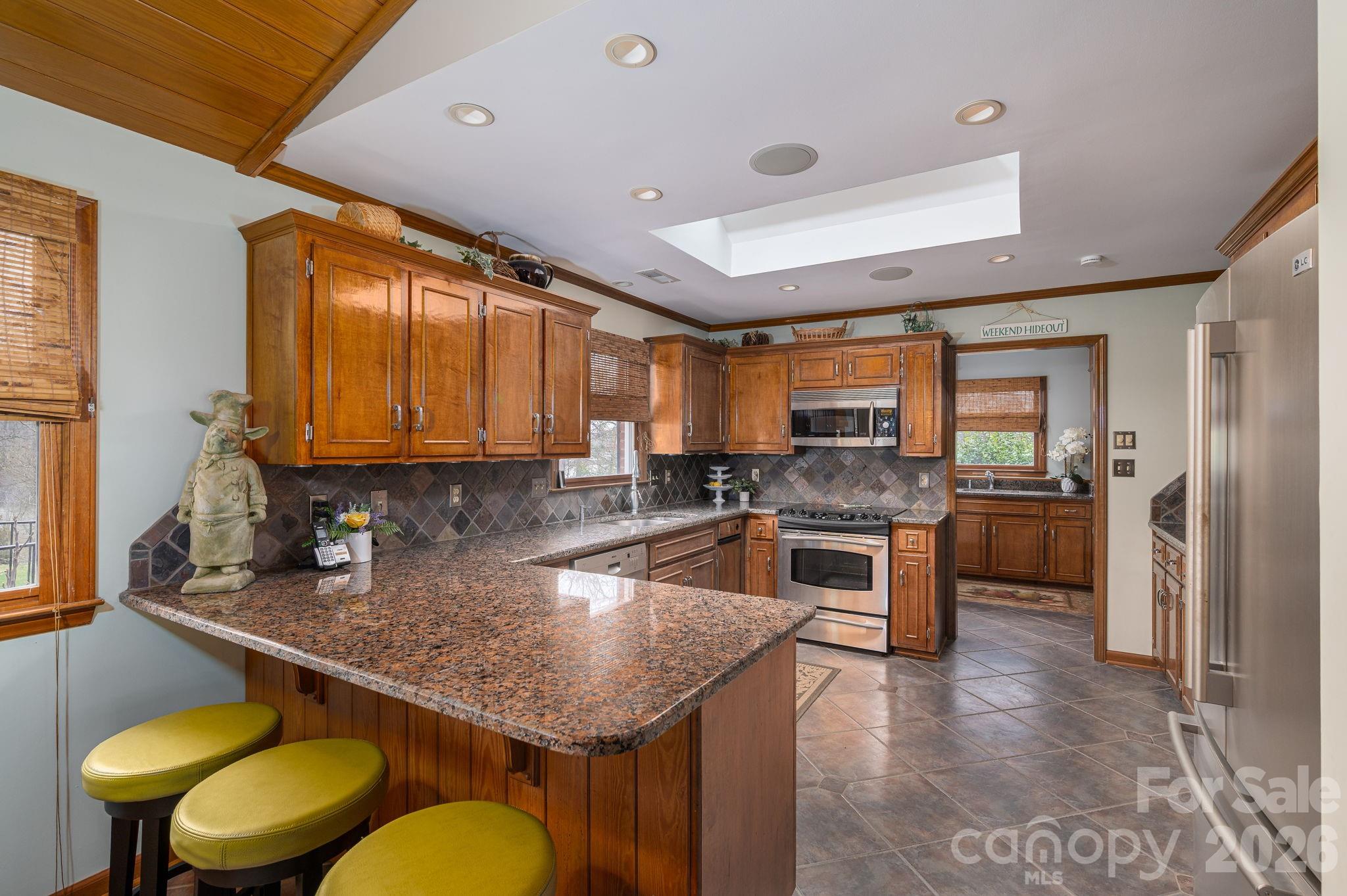 872 Armstrong Road Belmont, NC 28012 - Photo 25 of 48 a kitchen with a stove a sink and a refrigerator