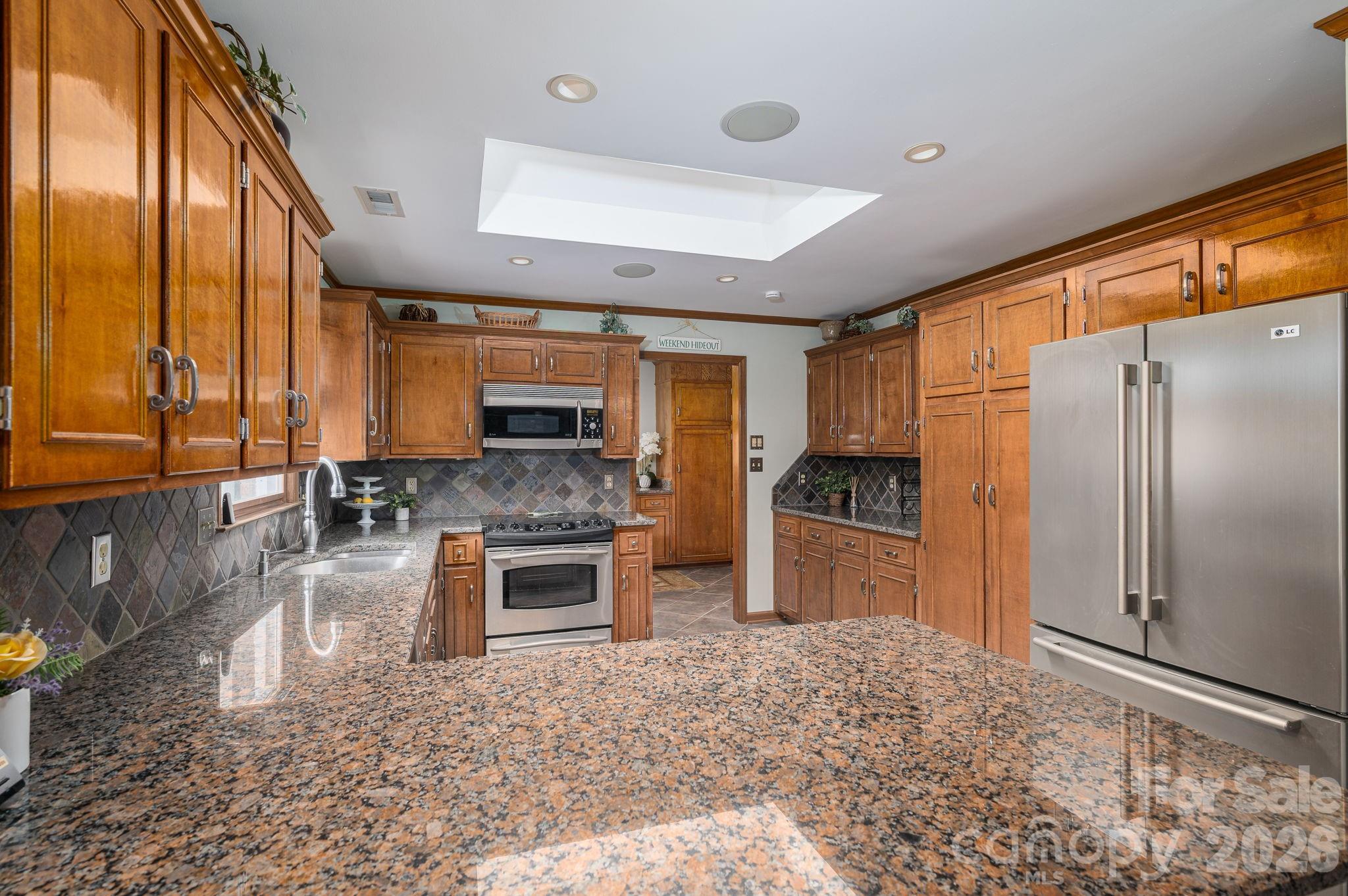 872 Armstrong Road Belmont, NC 28012 - Photo 26 of 48 a kitchen with stainless steel appliances granite countertop a refrigerator a stove and a sink with granite countertops