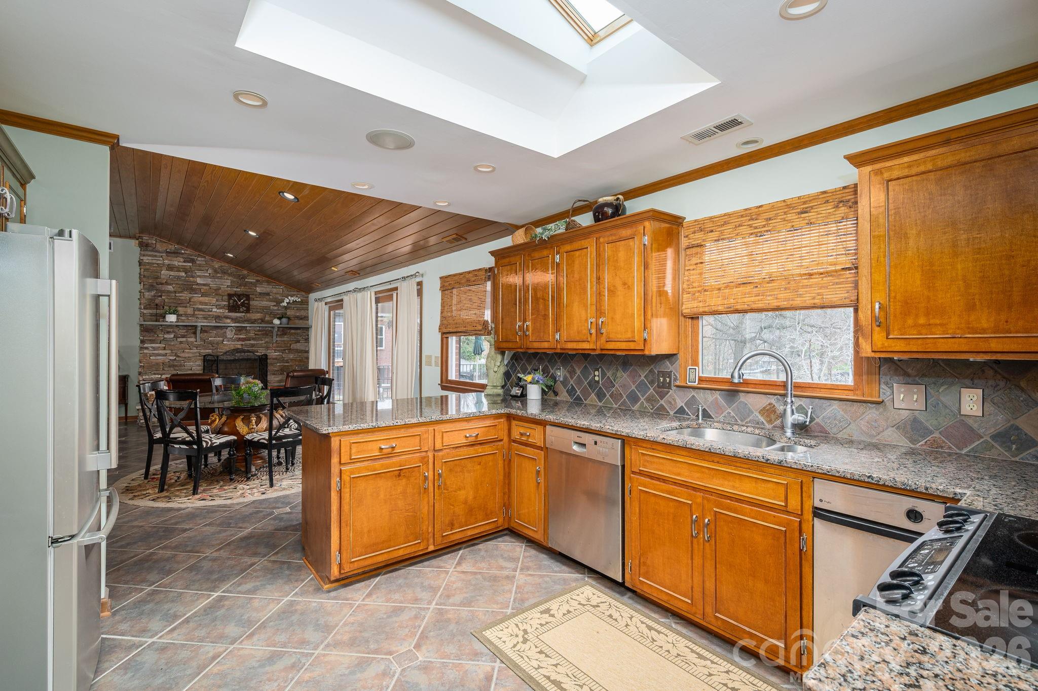 872 Armstrong Road Belmont, NC 28012 - Photo 28 of 48 a kitchen with stainless steel appliances granite countertop sink stove and granite counter top